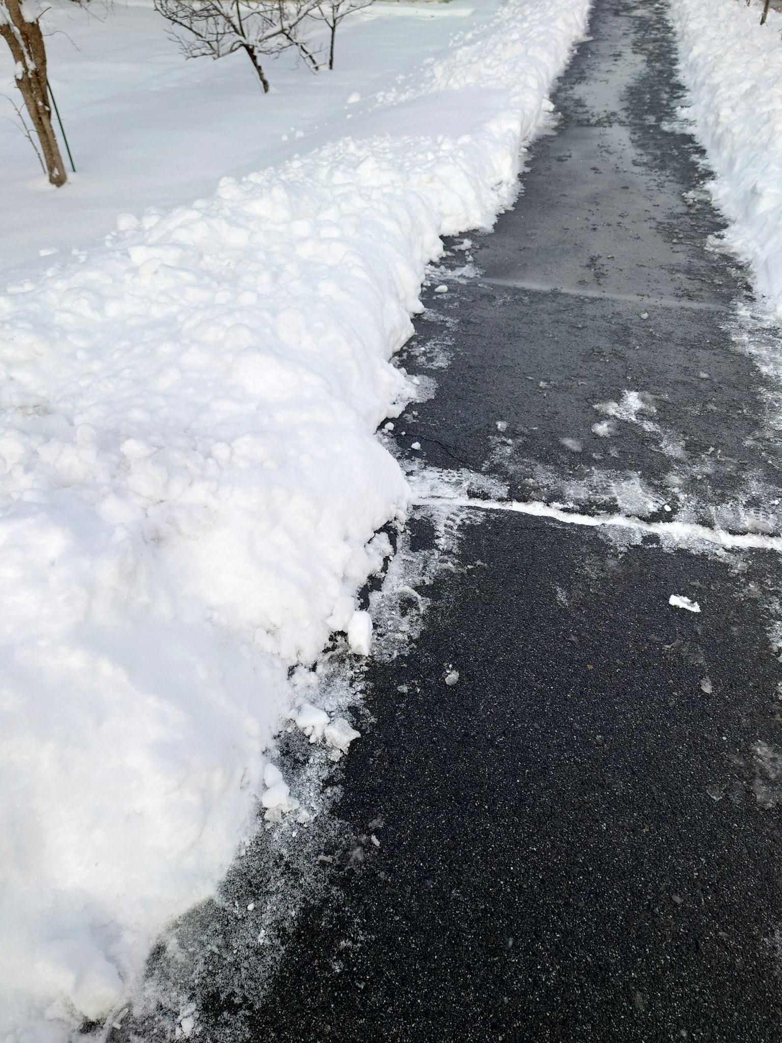 Snow-covered walkway with cleared edges