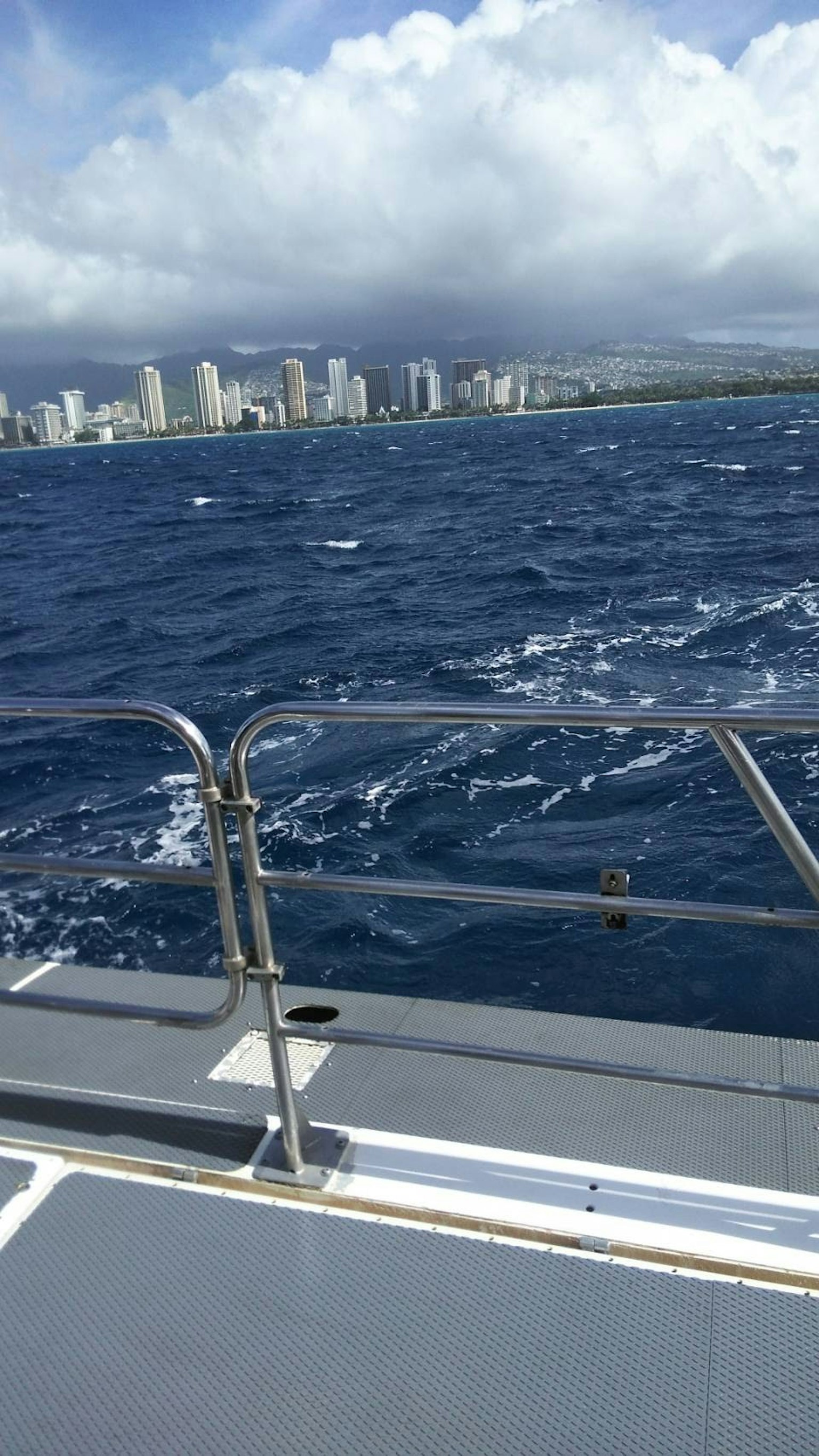 View of Honolulu skyline and Diamond Head from a boat on the ocean