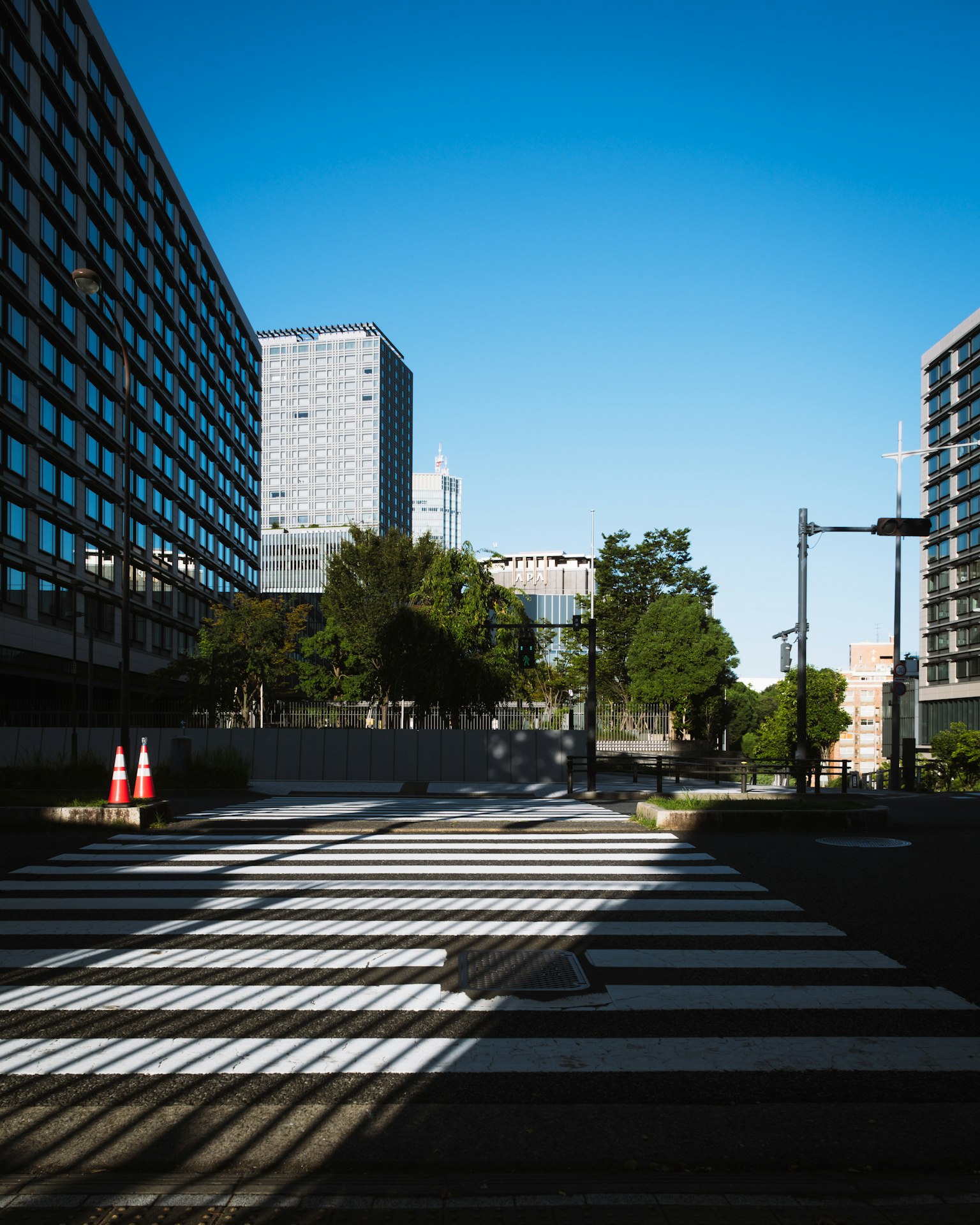 Crosswalk and buildings under a clear blue sky