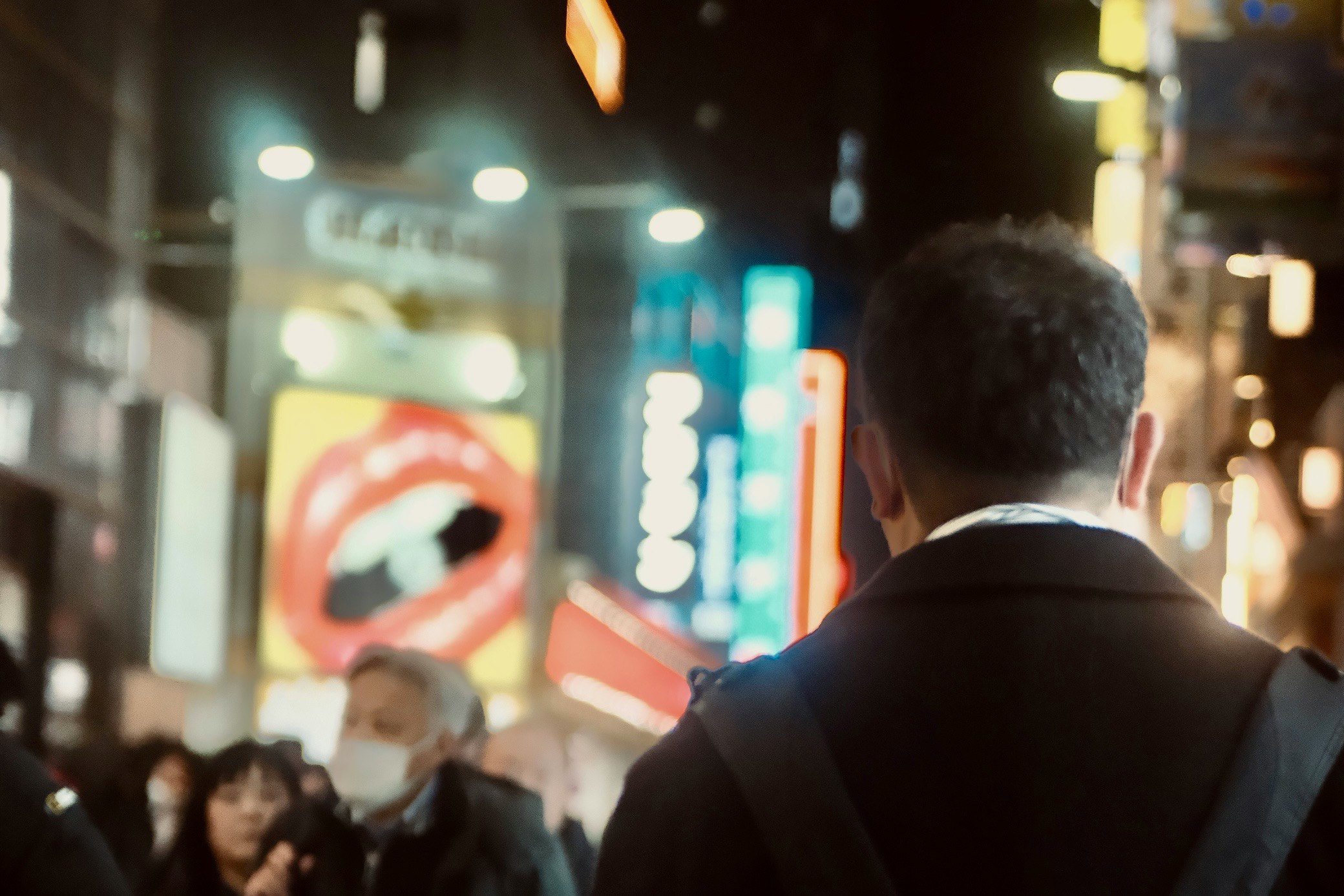 back view of a person in a crowded night street