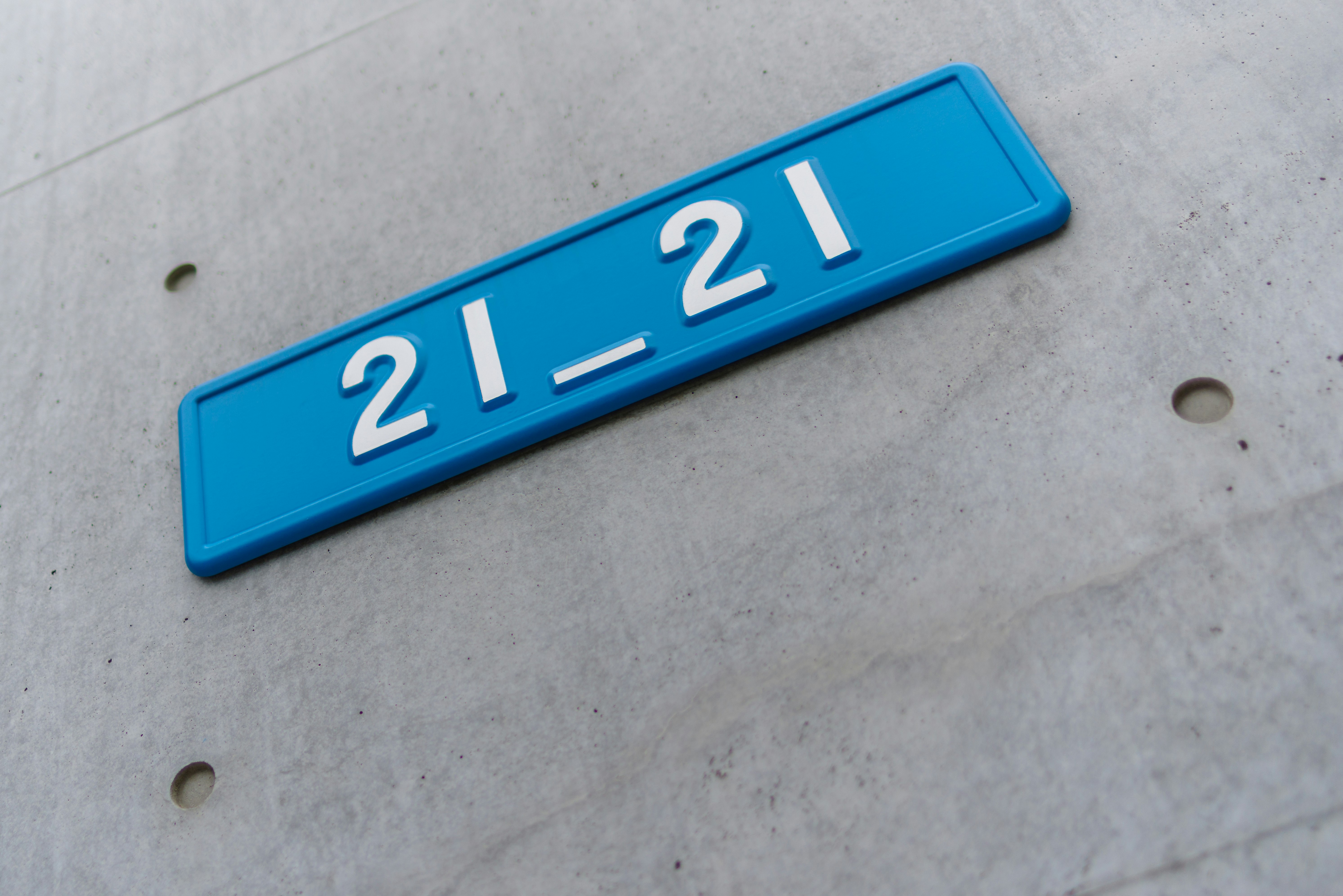 blue vehicle license plate with “21-21”
