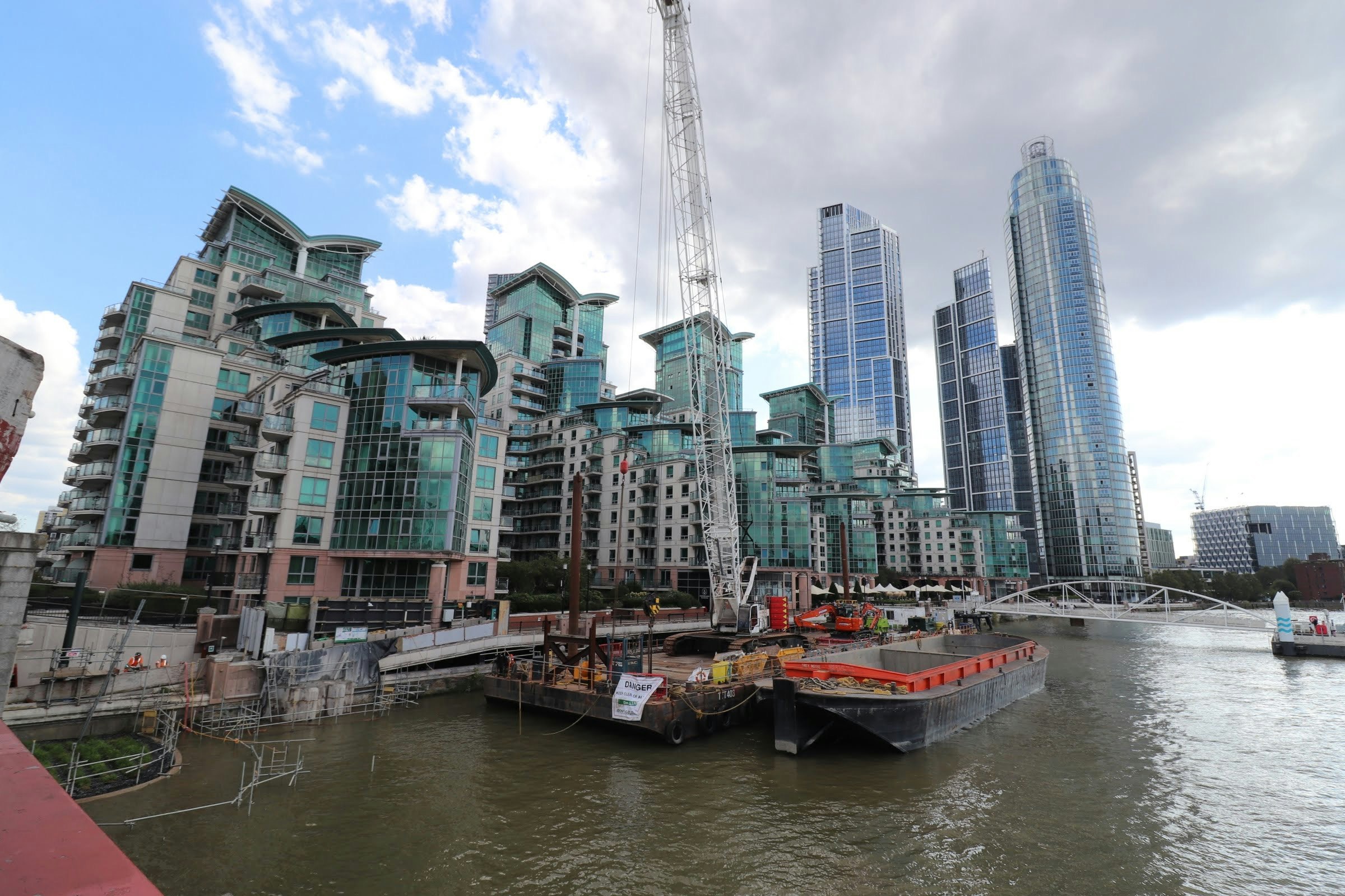 riverside high-rise buildings with moored boats