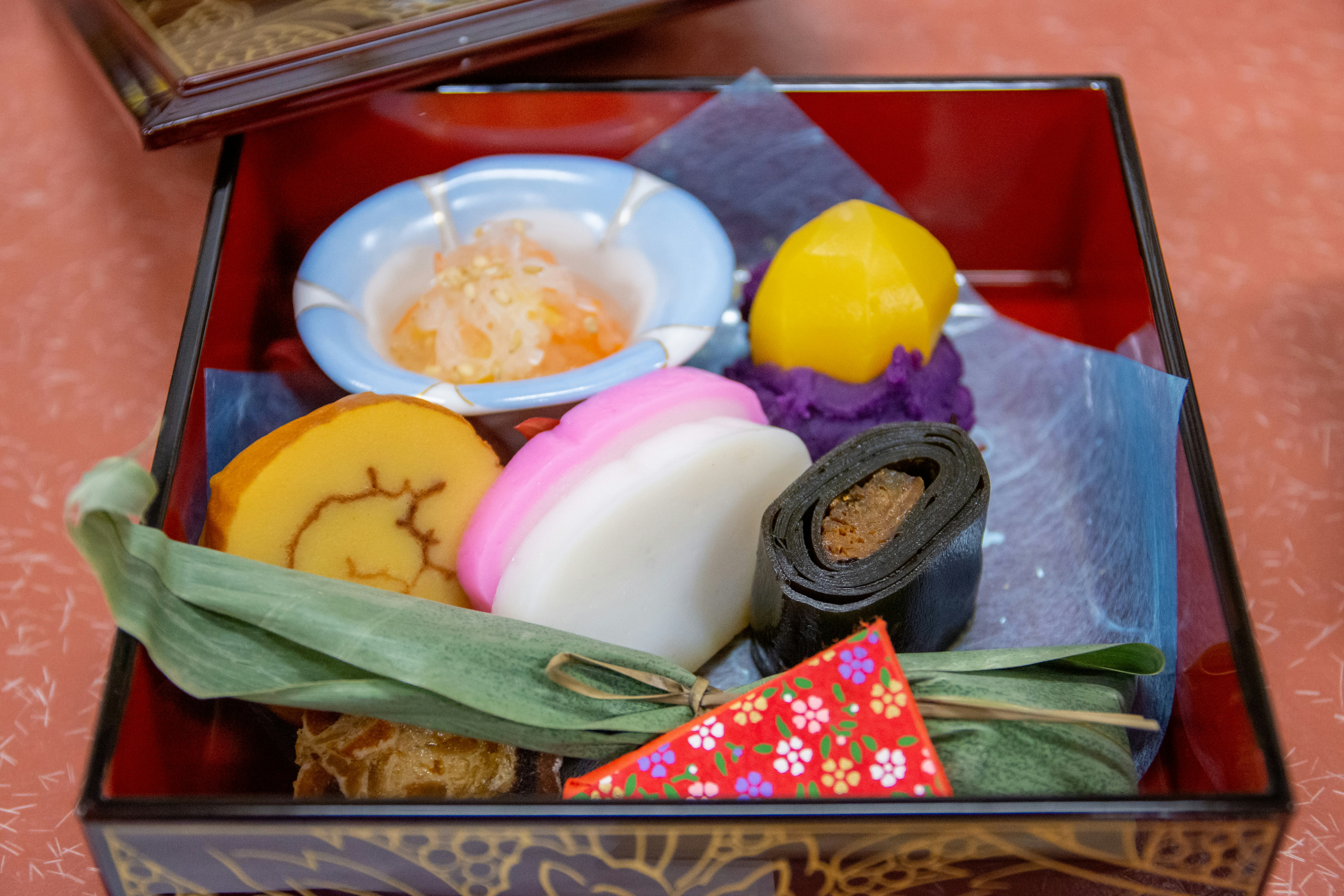 An assortment of beautiful Japanese sweets in a red box