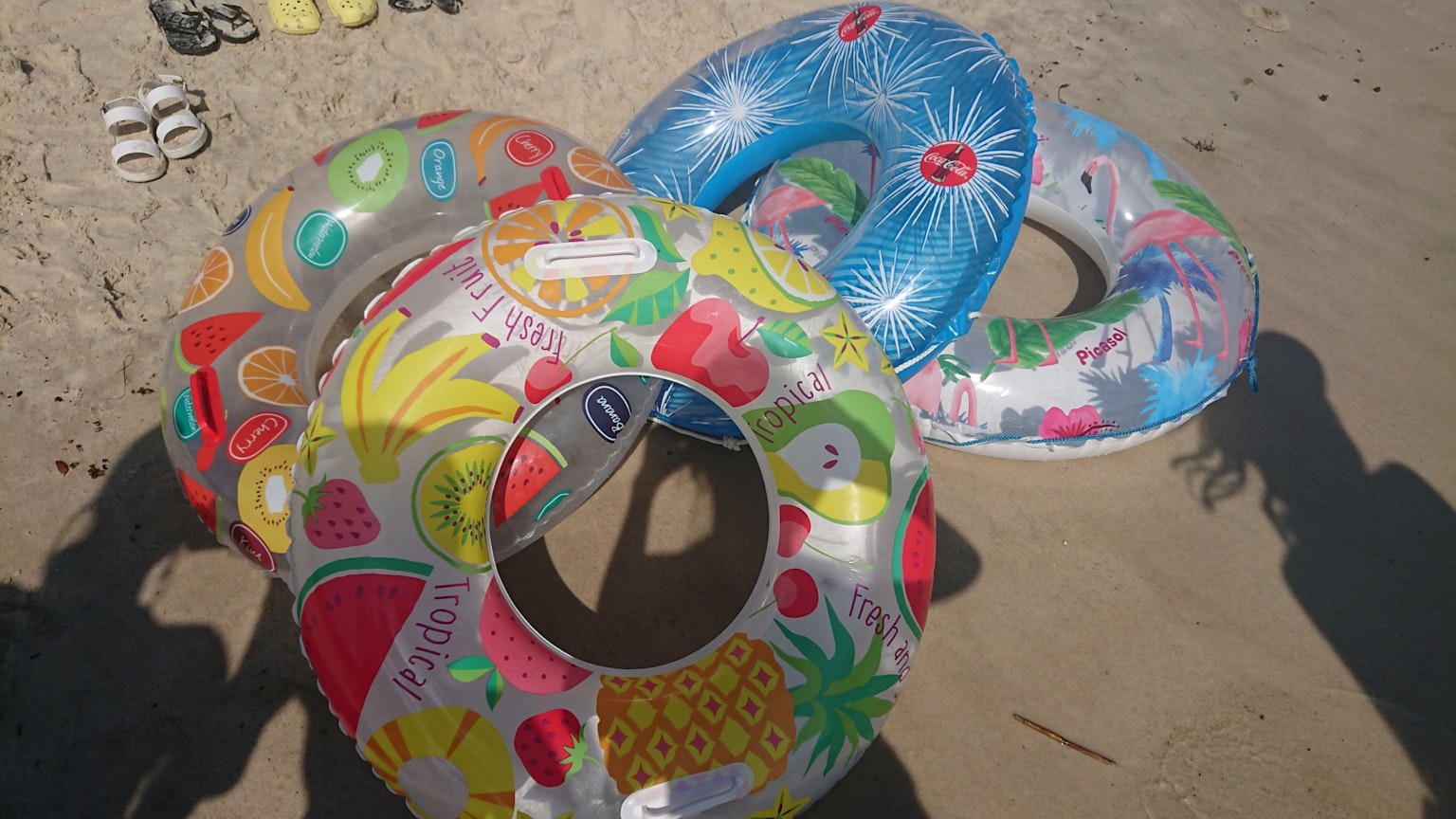 Group of colorful inflatable rings on the beach