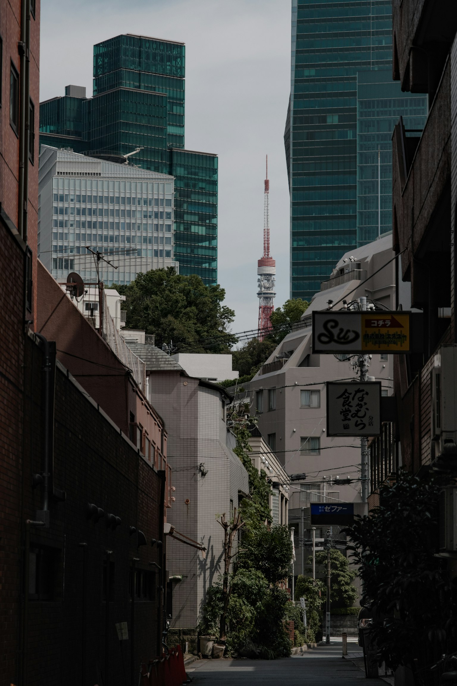 Narrow street view with Tokyo Tower and skyscrapers in the background
