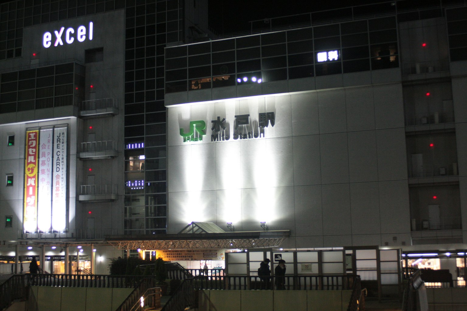 Exterior of Excel building at night with bright signage