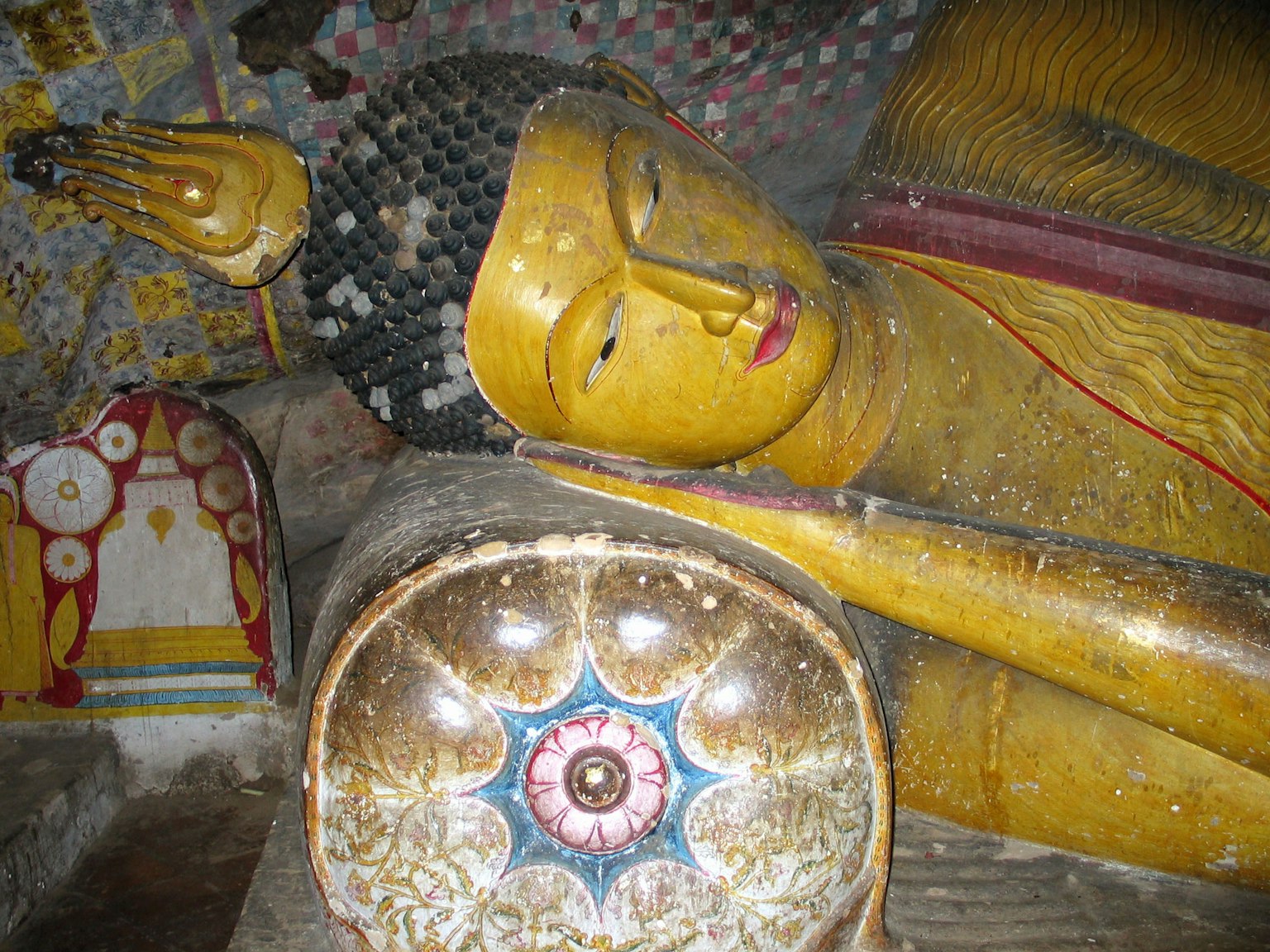 Reclining Buddha statue with intricate details and vibrant colors