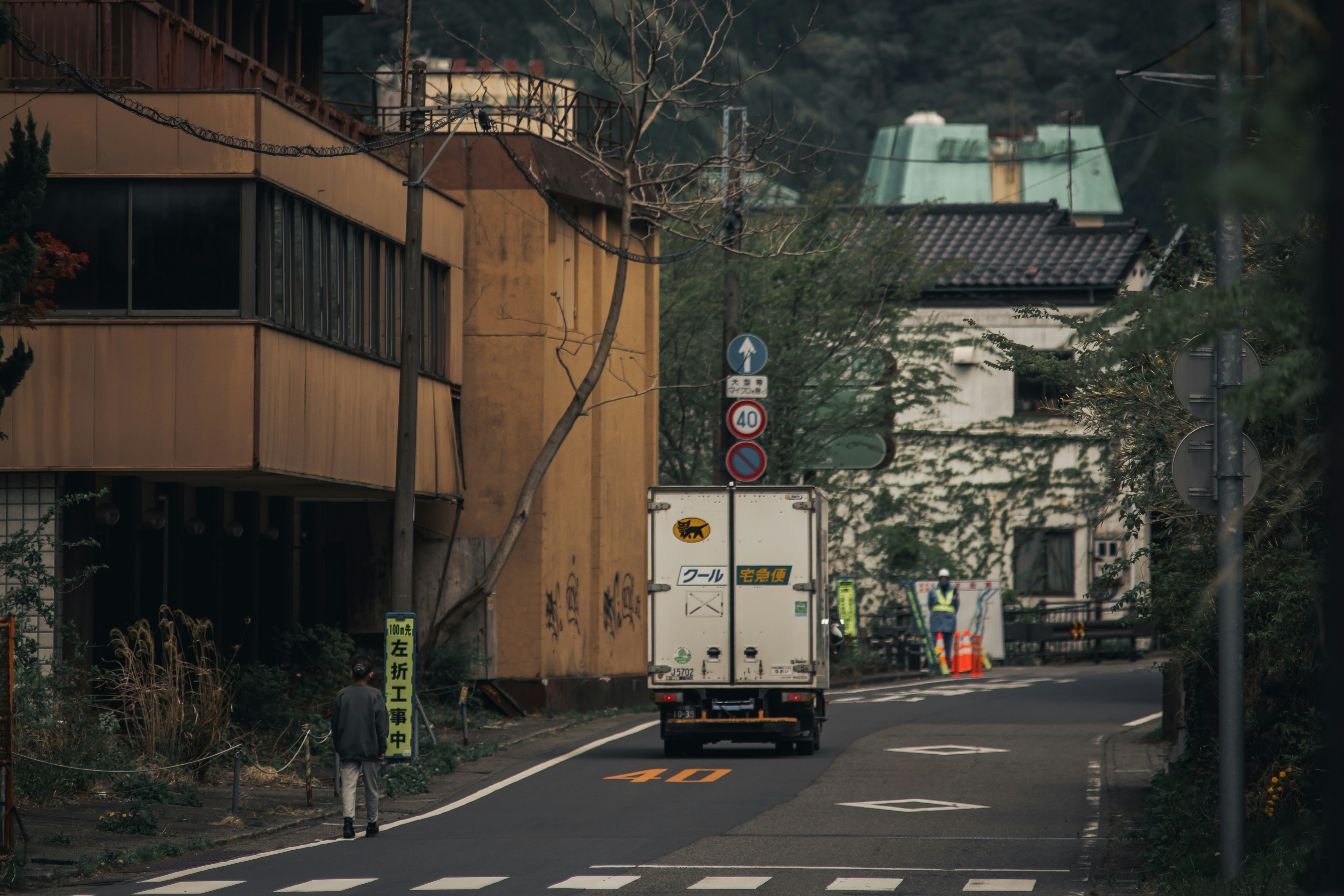 路地を走るトラックと街灯のある交差点の風景