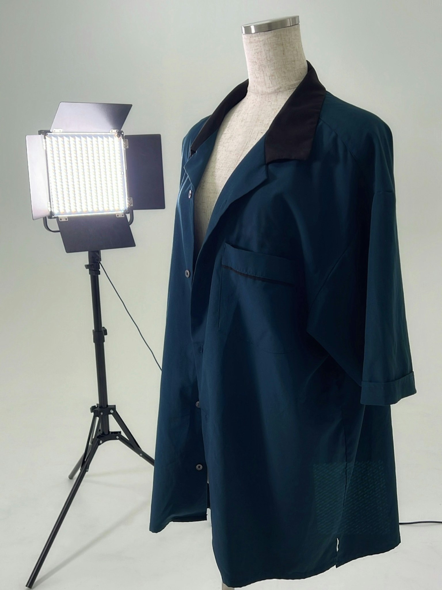 Mannequin displaying a blue shirt with studio lighting