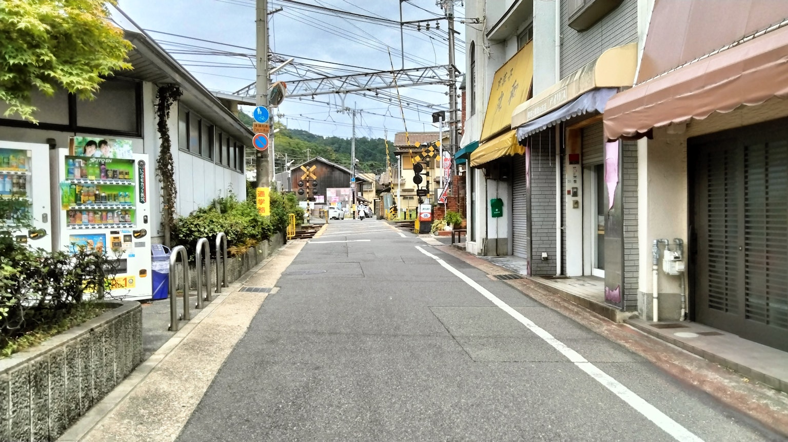 ถนนญี่ปุ่นที่เงียบสงบเรียงรายไปด้วยร้านค้าและสายไฟ