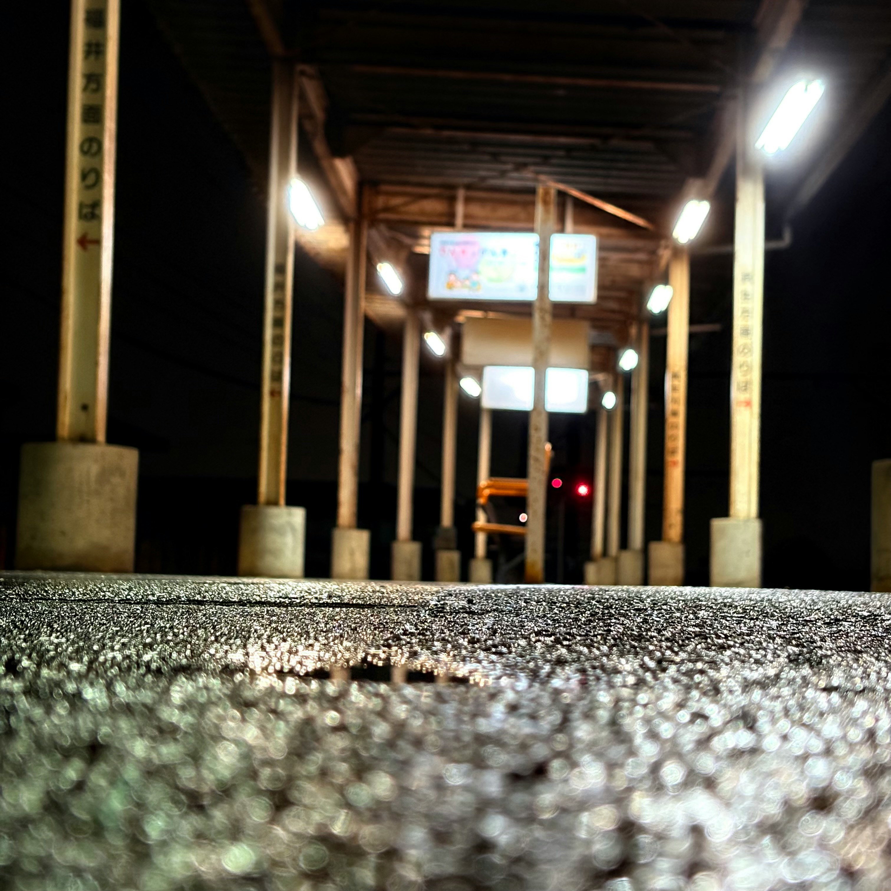 夜中の駅ホームの線路と明かり