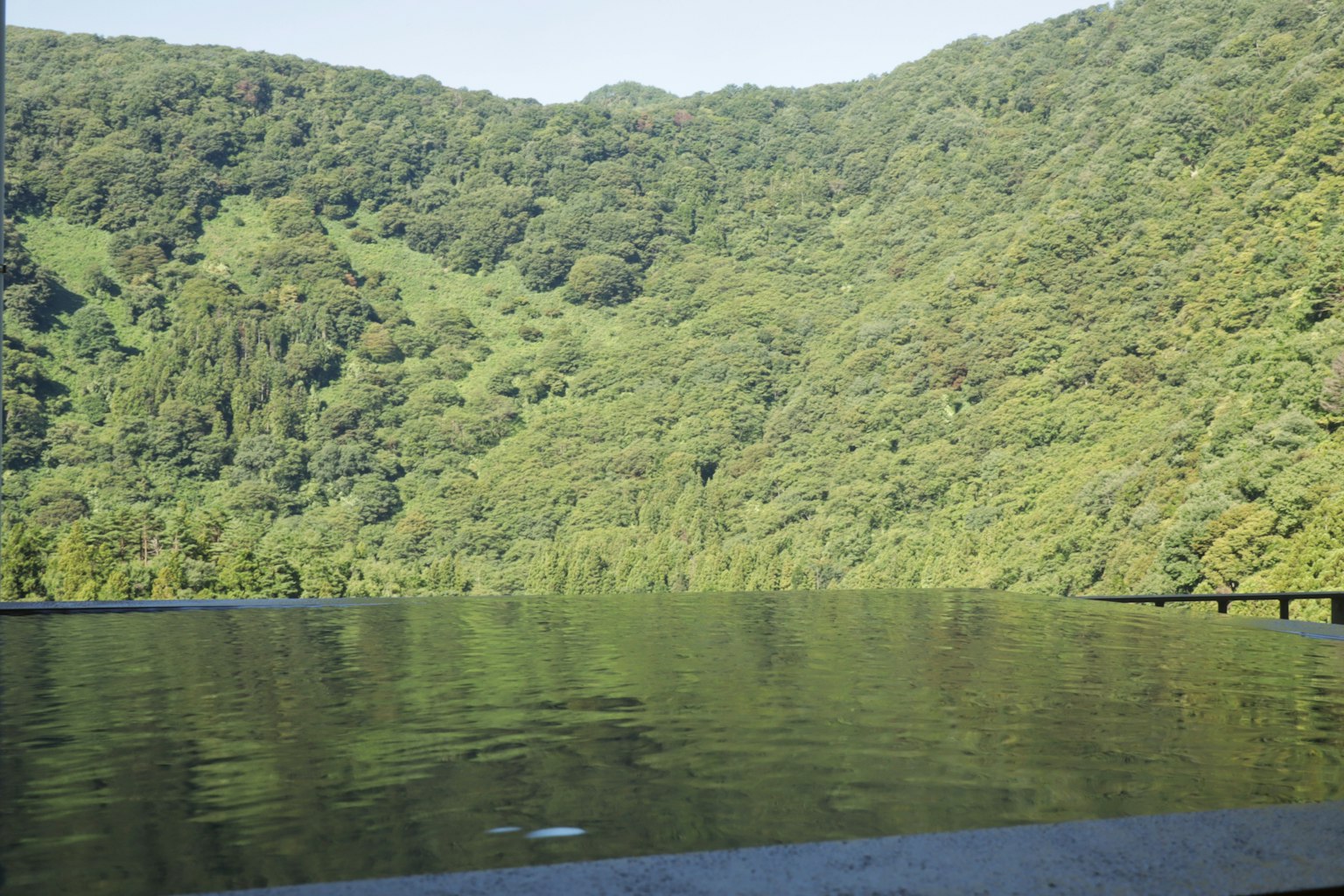 Lush green mountains with a tranquil lake