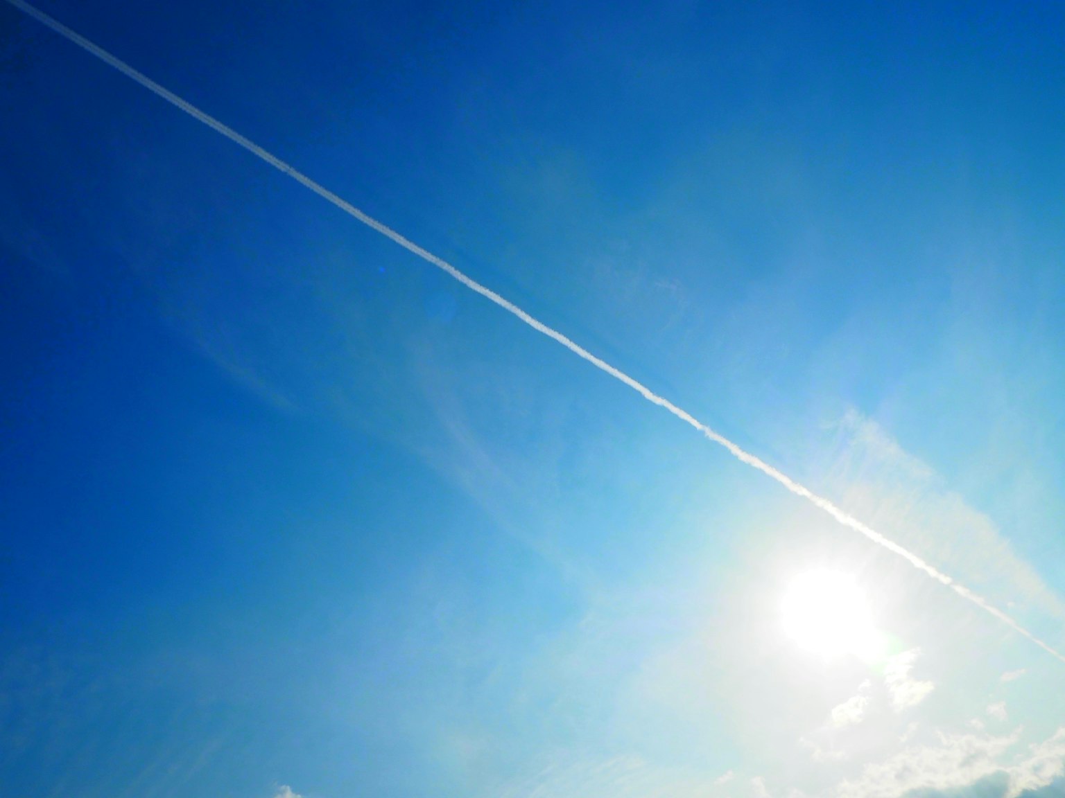 Un cielo azul claro con una estela blanca que se extiende