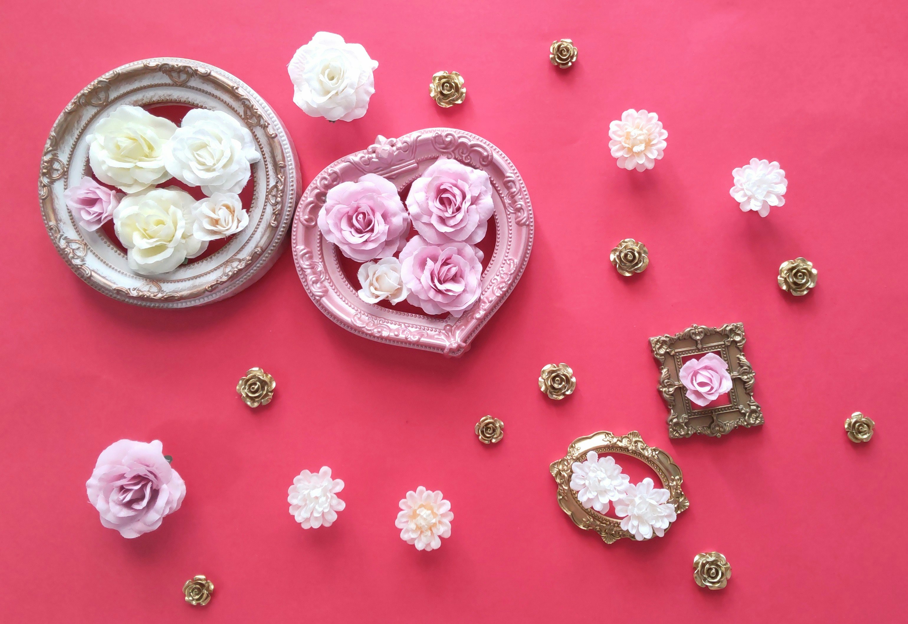 heart-shaped and framed pink-and-white flowers on a pink background