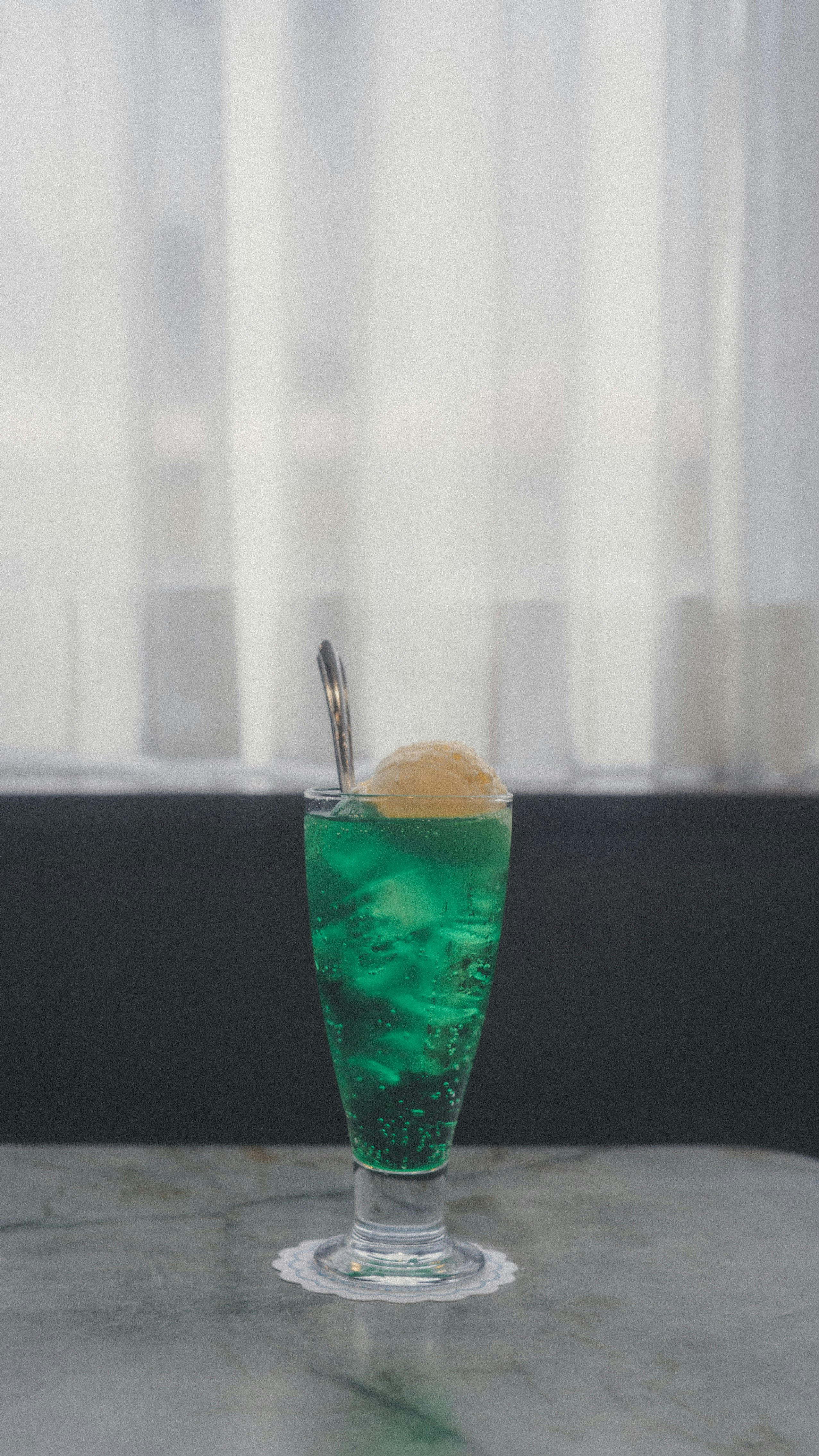 vibrant green cocktail in a glass