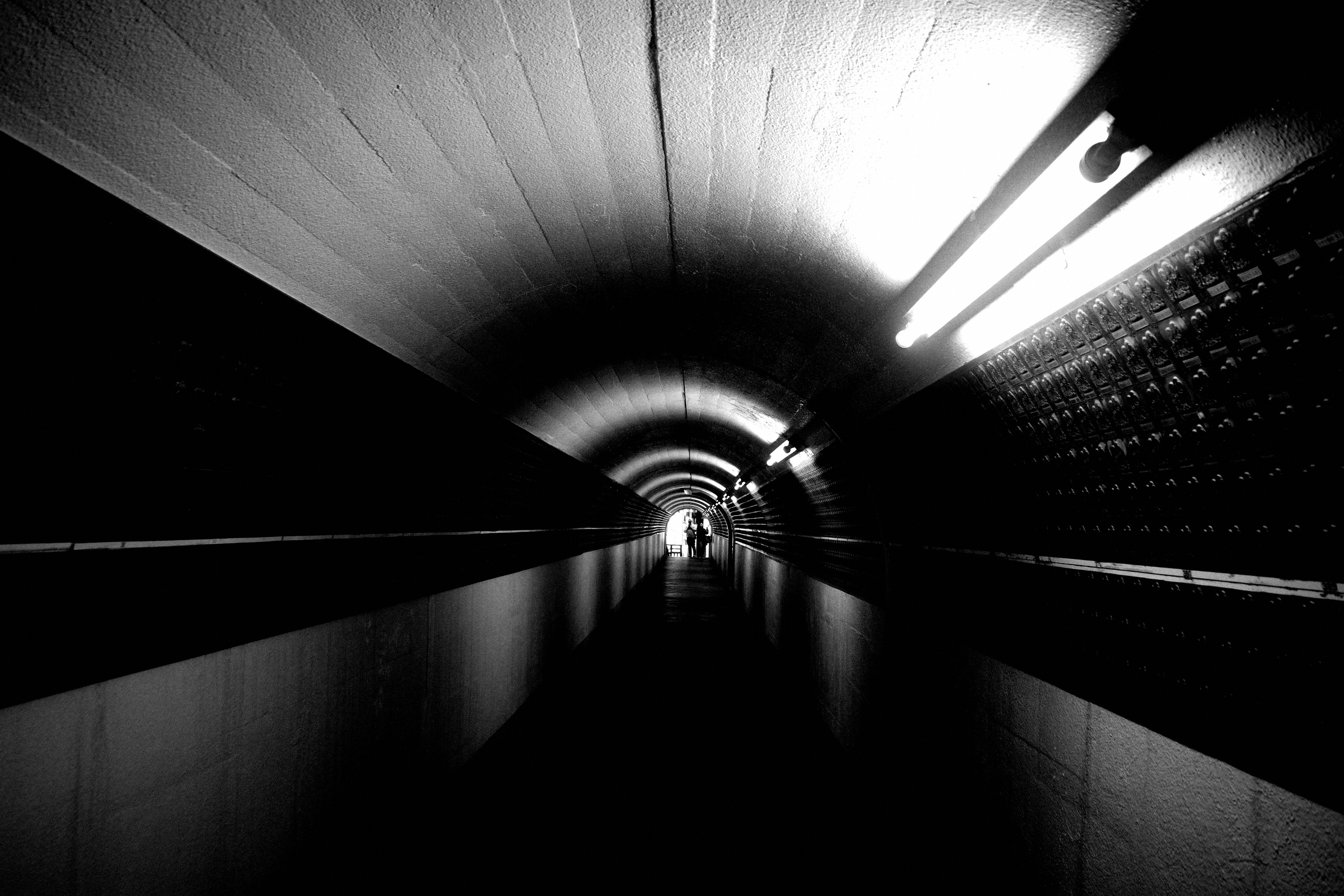 monochrome tunnel corridor with radiating ceiling lights