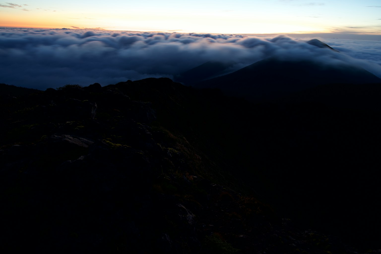 View of a cloud sea at sunset from a mountain peak