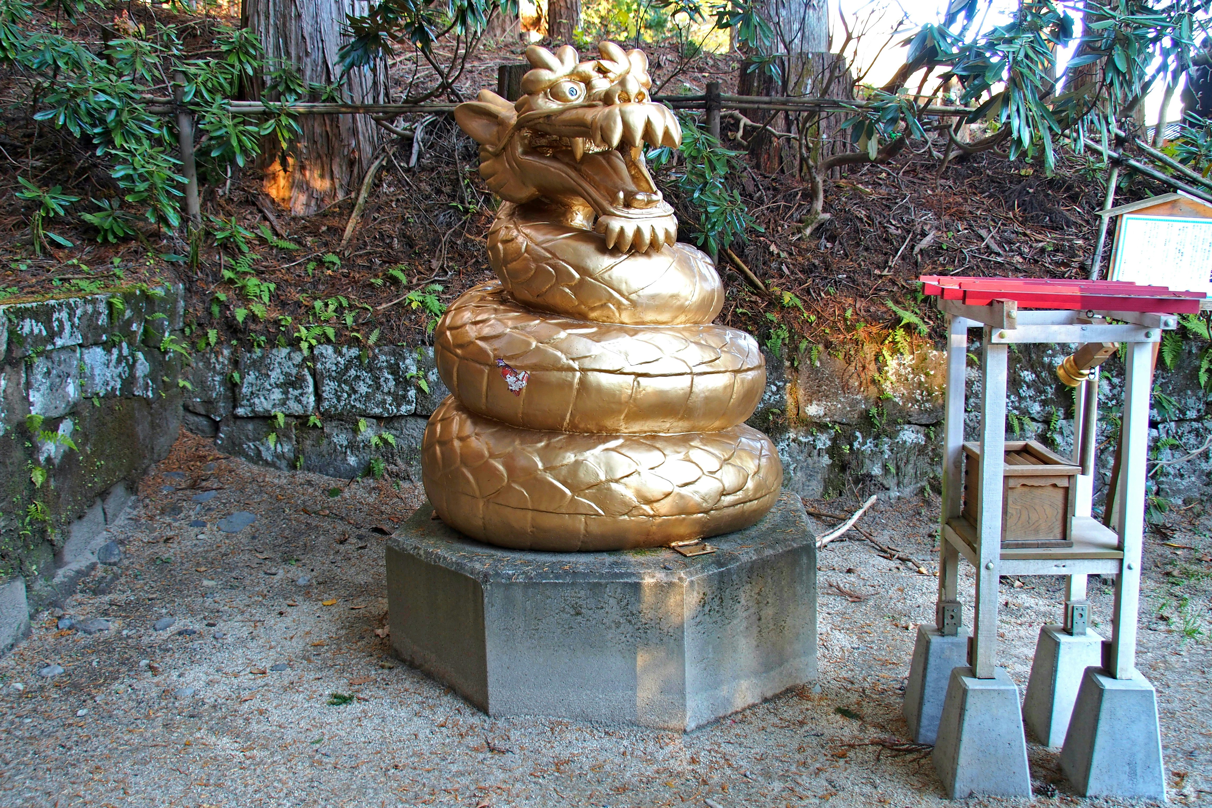石座上的金色龙雕像与小型供奉台