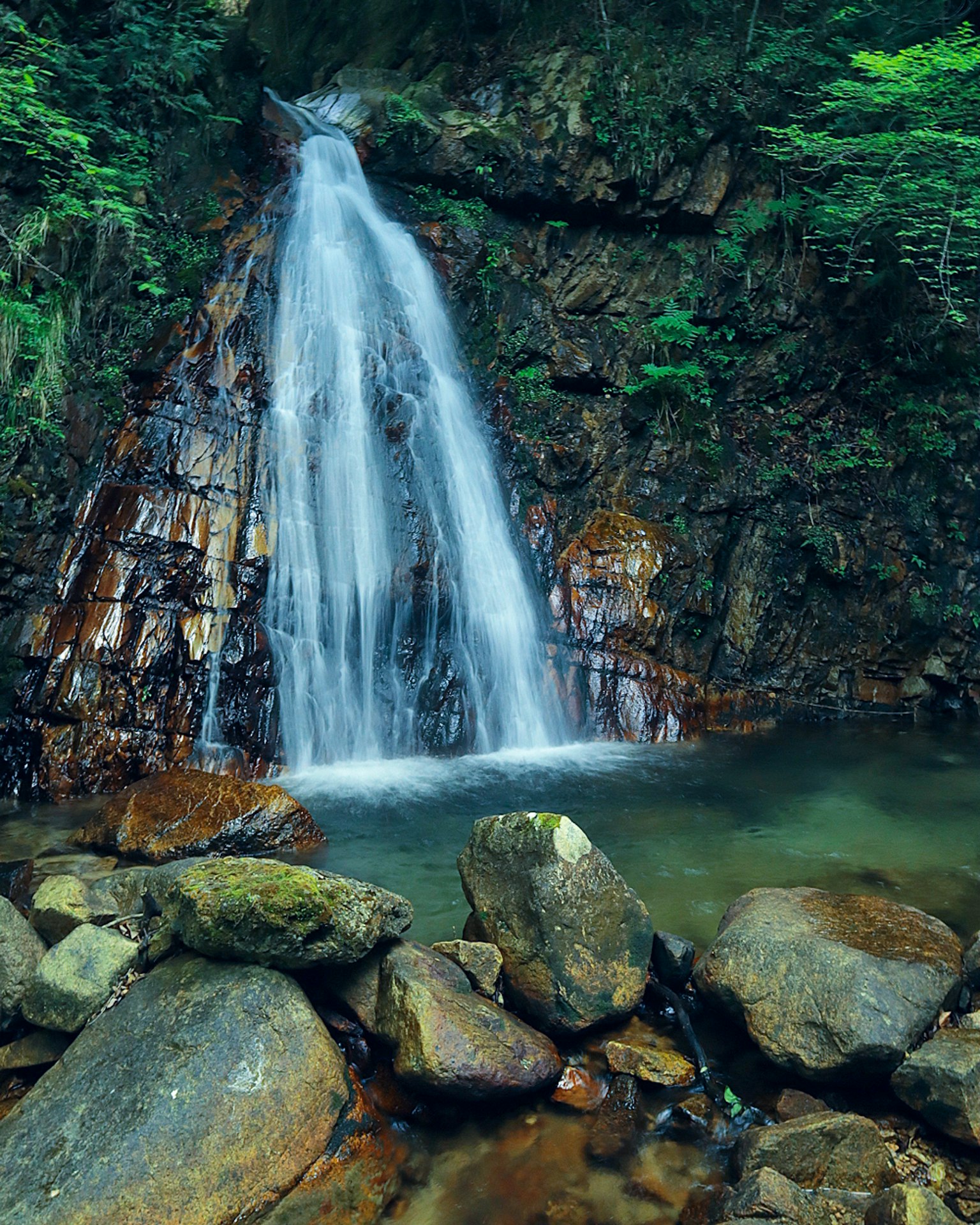 A beautiful waterfall surrounded by rocks and greenery