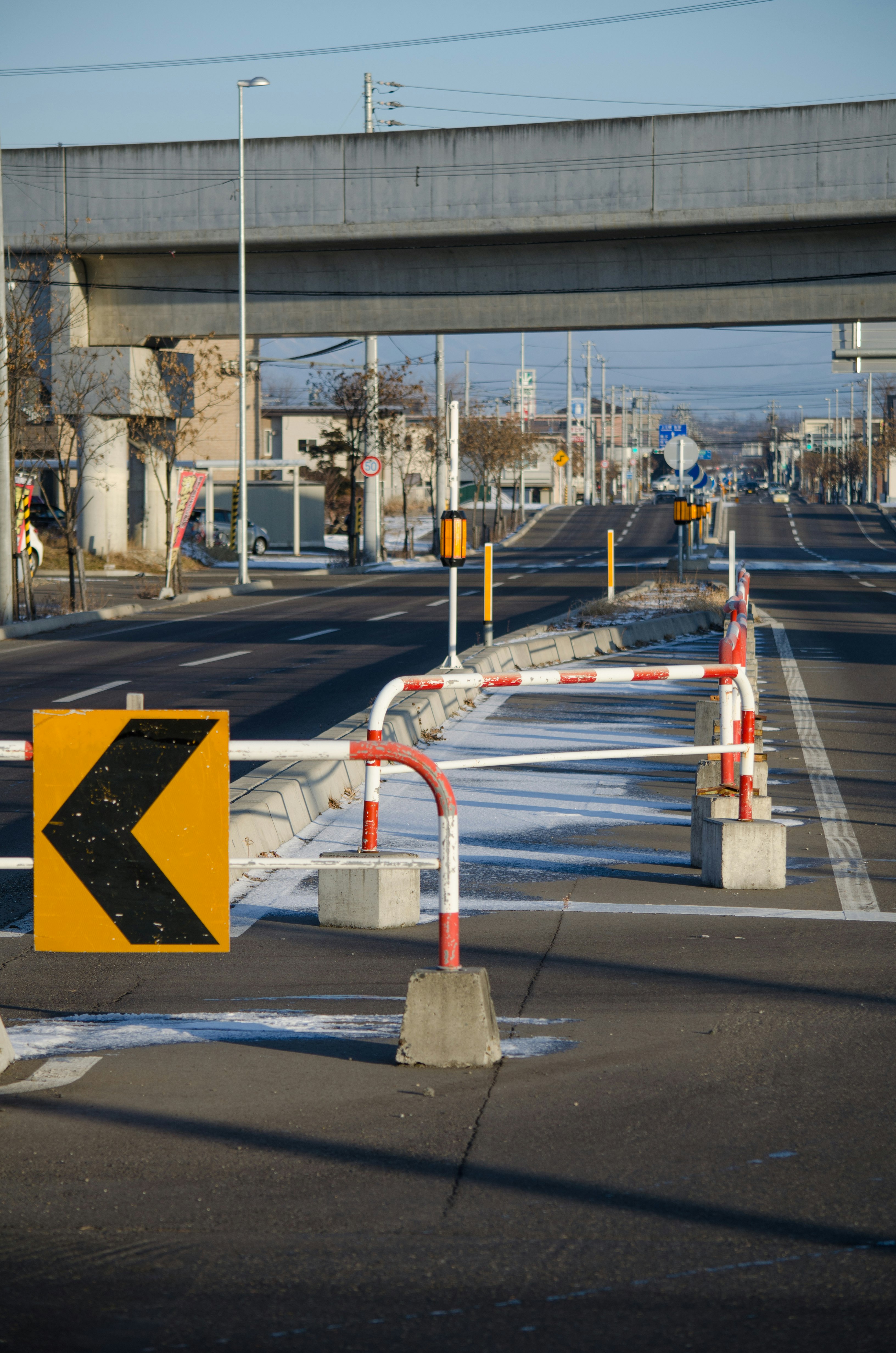 Road under an elevated structure with traffic barriers