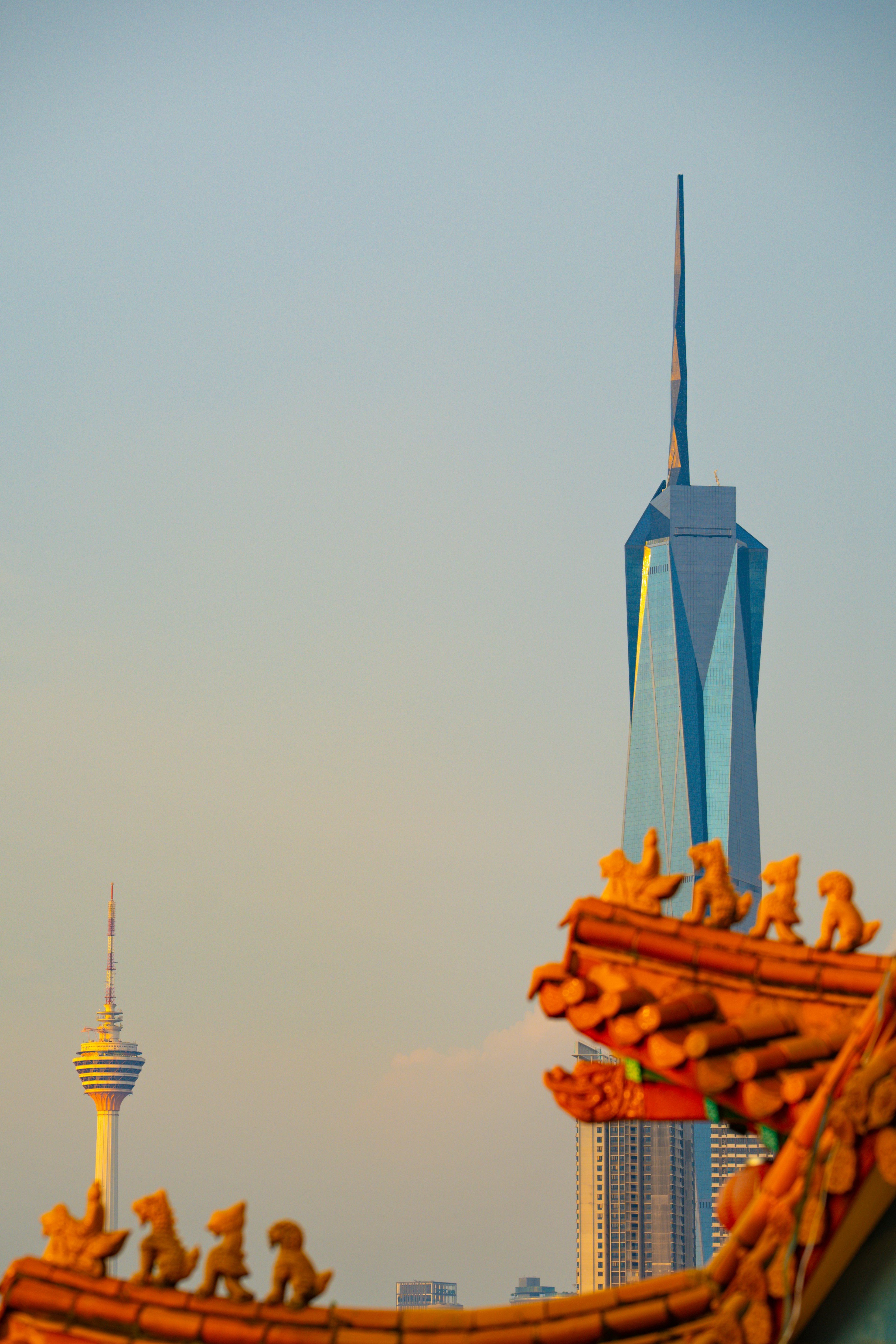 city skyline view with tall towers and golden sculptures