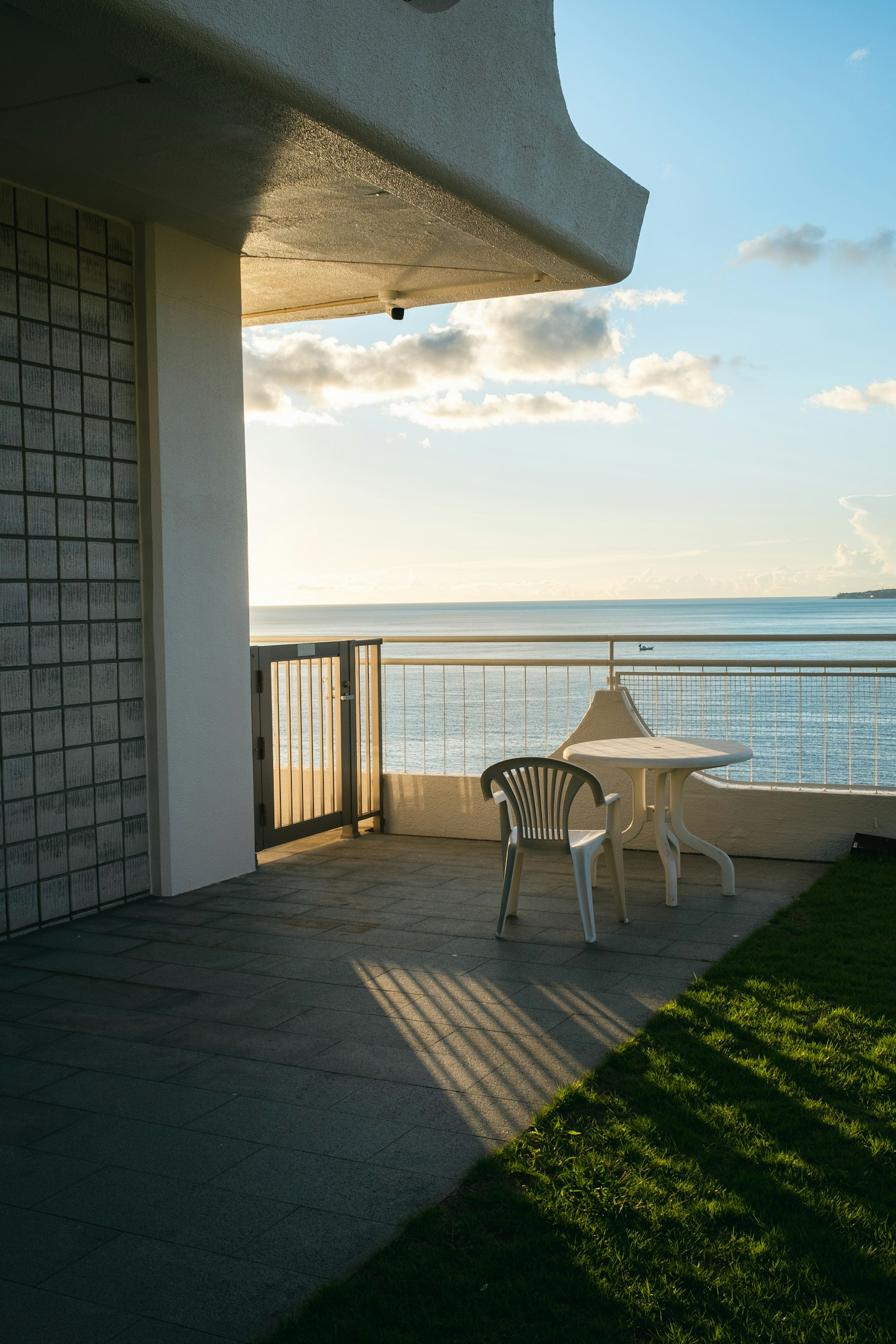 White table and chairs on a terrace overlooking the sea