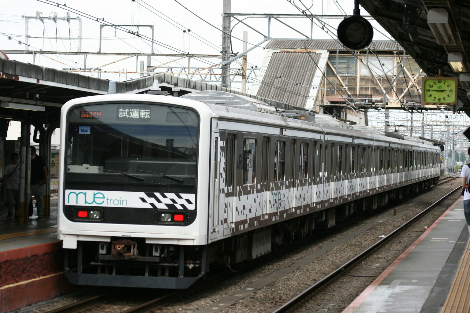 A white train stopped at a station