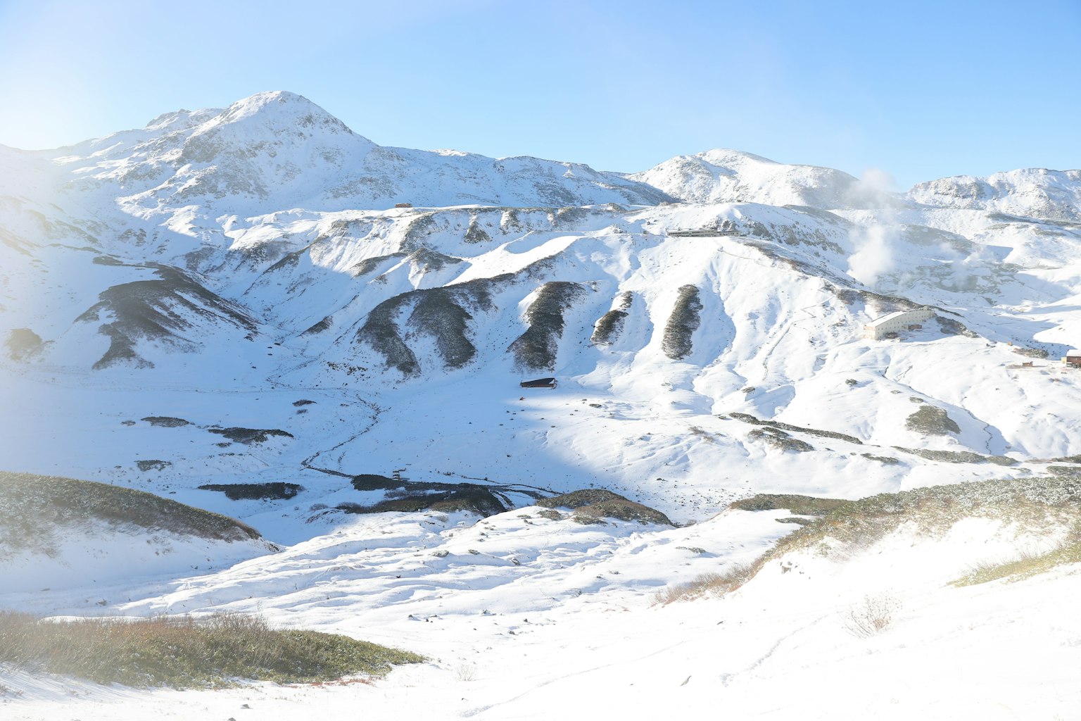 Snow-covered mountains under a clear blue sky