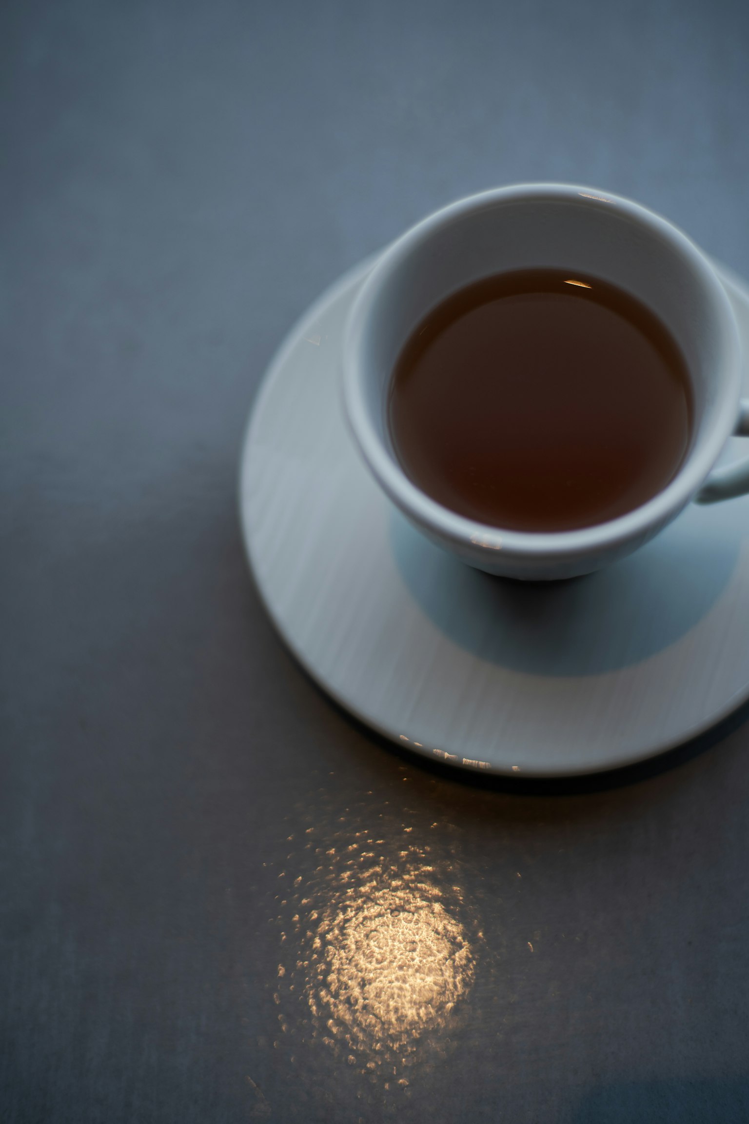 Una tazza di caffè con piattino posata su un tavolo