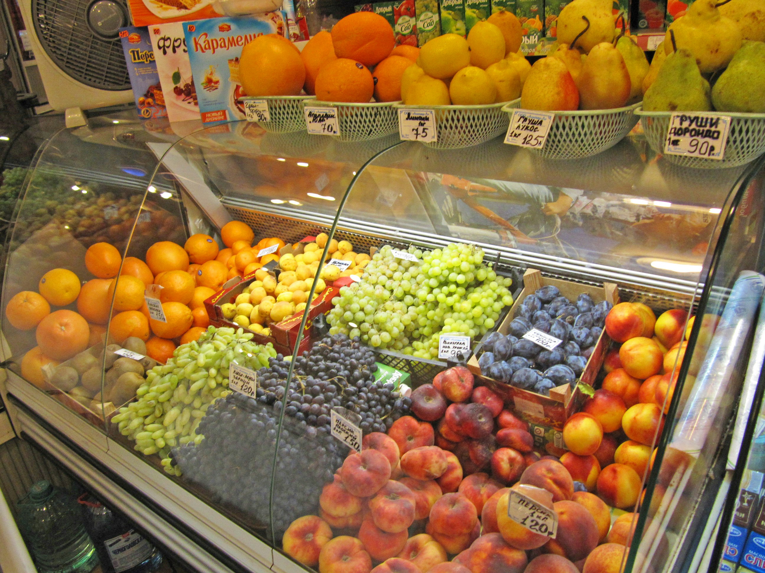 colorful fruit display case at a shop