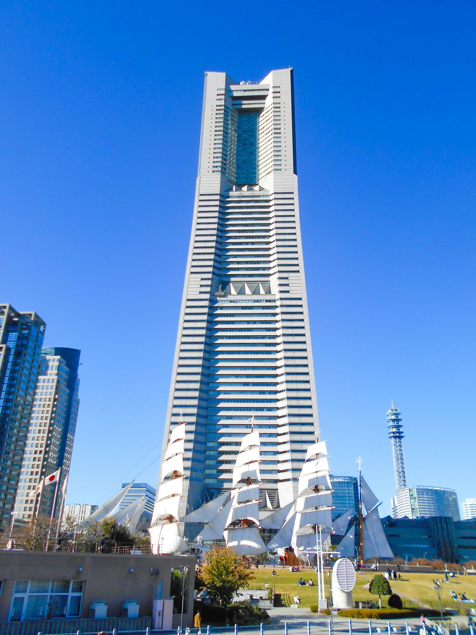 Torre Landmark di Yokohama con edifici moderni sotto un cielo azzurro