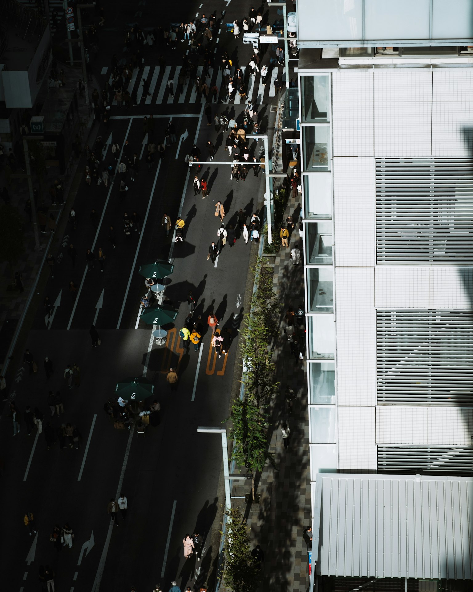 Aerial view of a busy intersection with pedestrians and vehicles