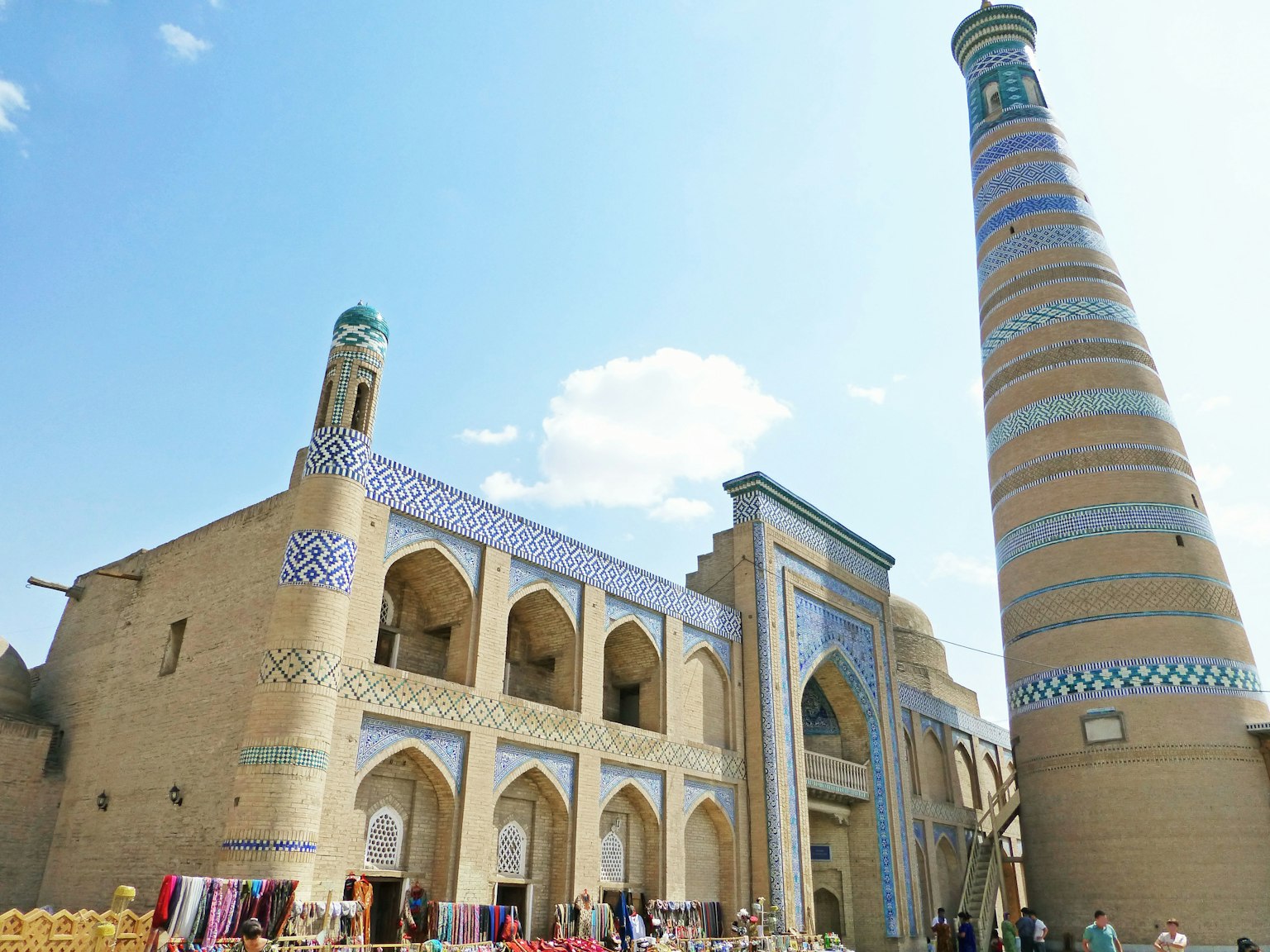 Historic building with a tall minaret under a blue sky