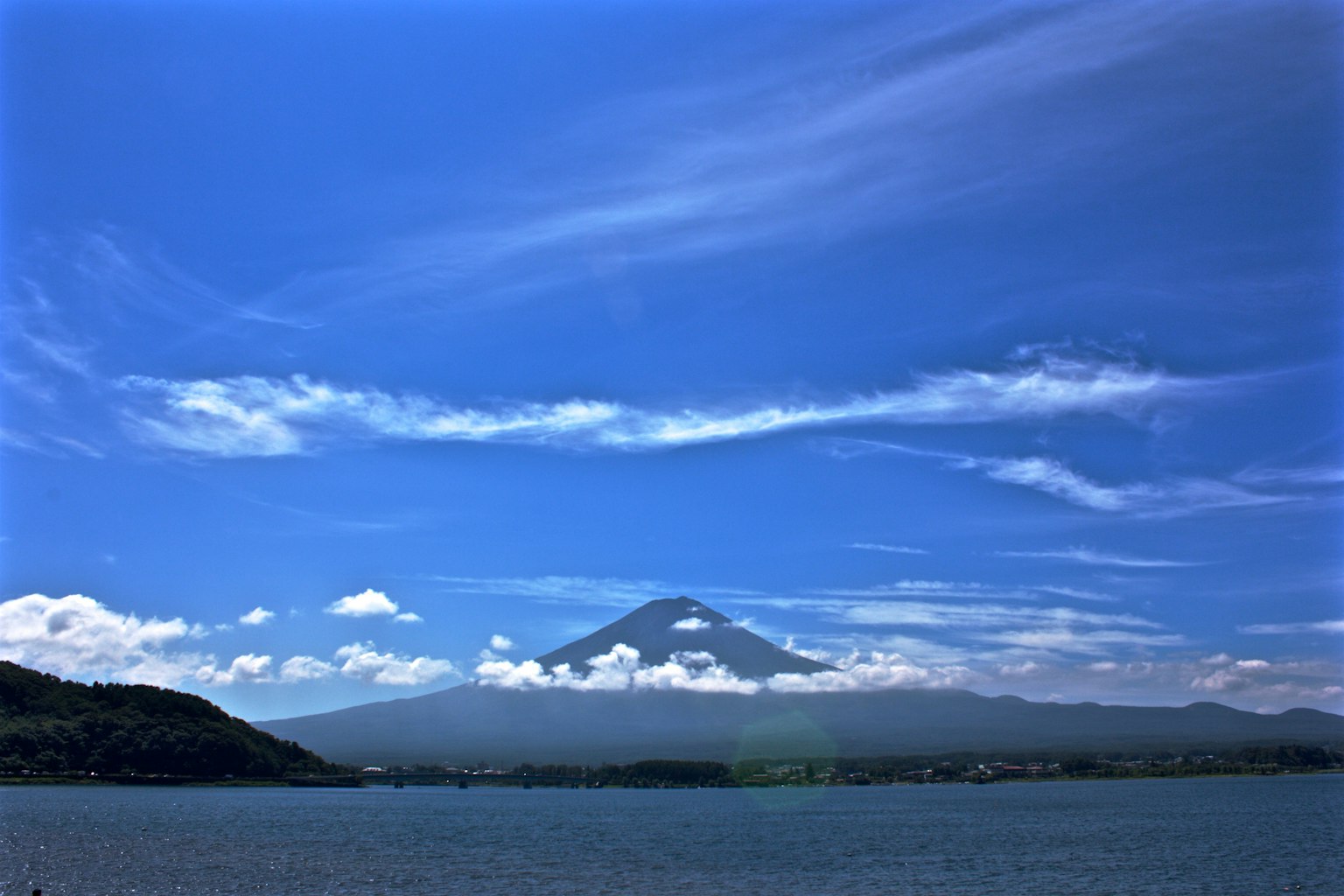 Mount Fuji visible under a blue sky with white clouds