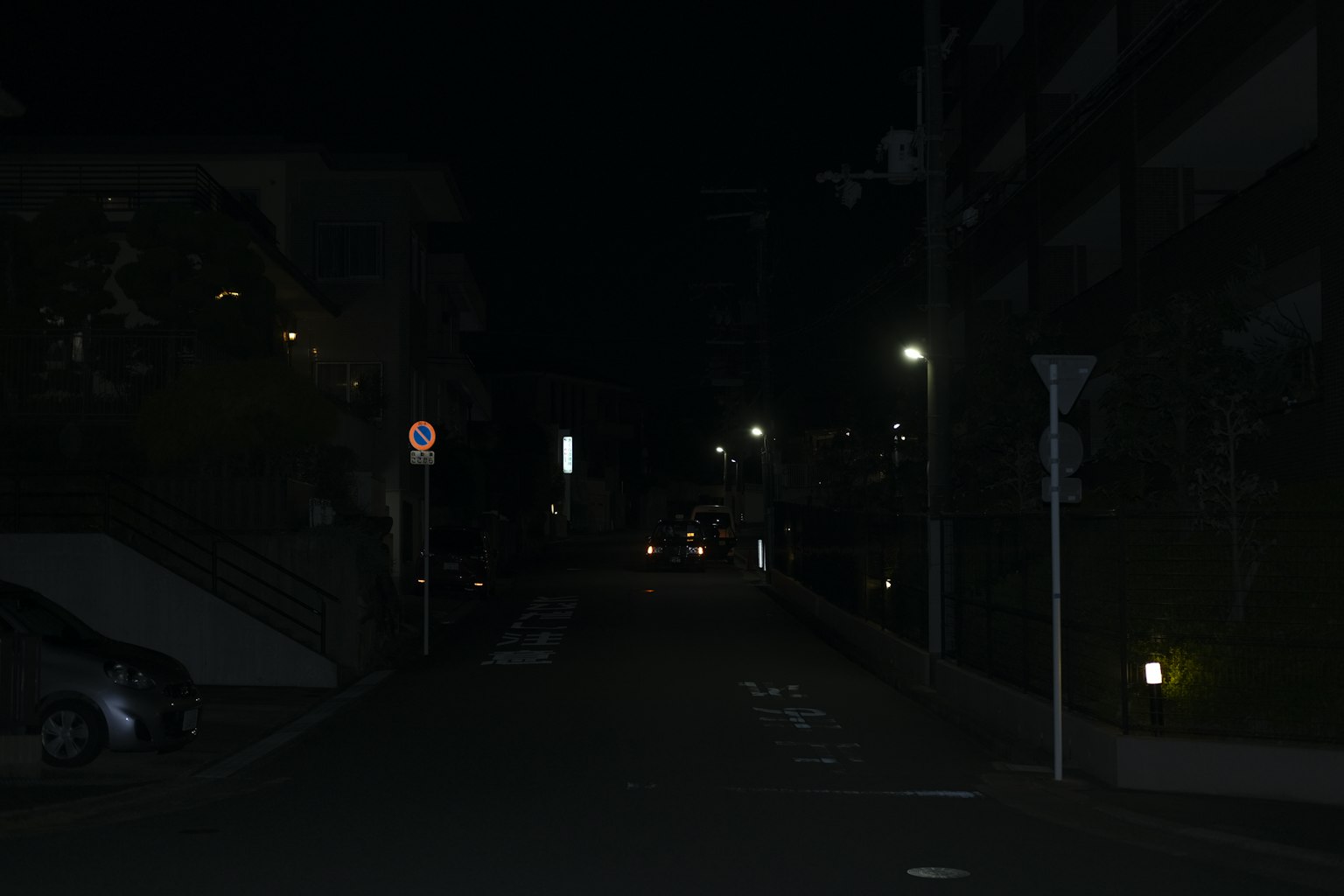 Escena de calle tranquila por la noche con farolas encendidas
