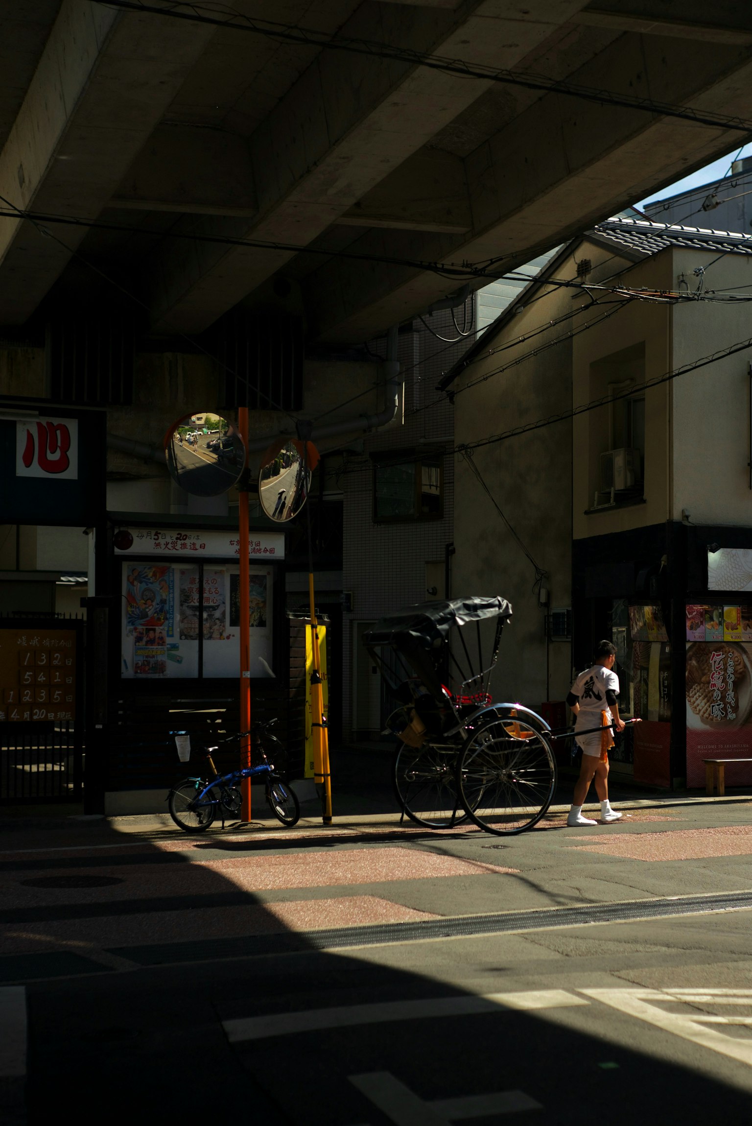 Daytime scene of a street corner with a bicycle parked in a commercial area