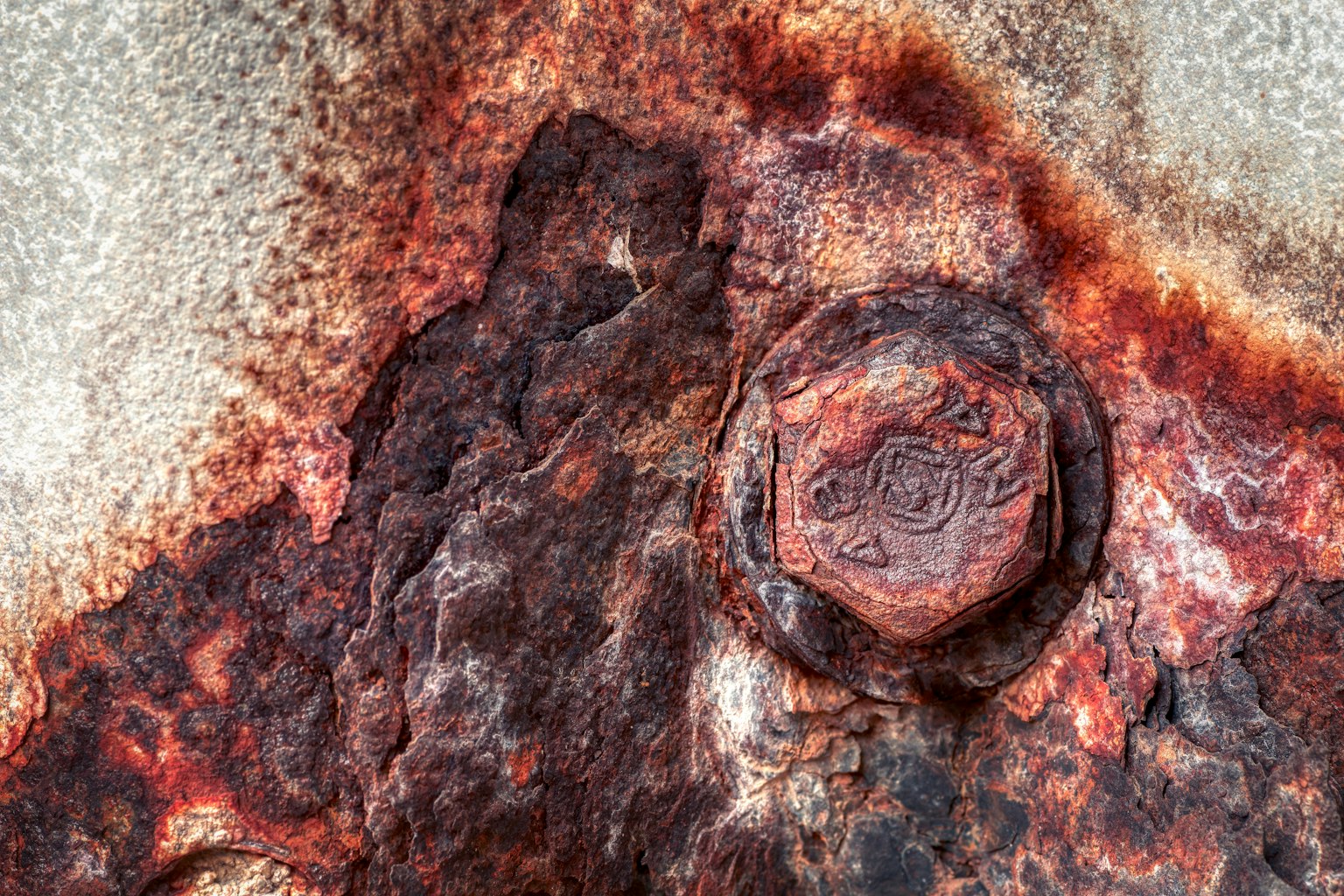 Close-up image of a rusted metal surface with a bolt