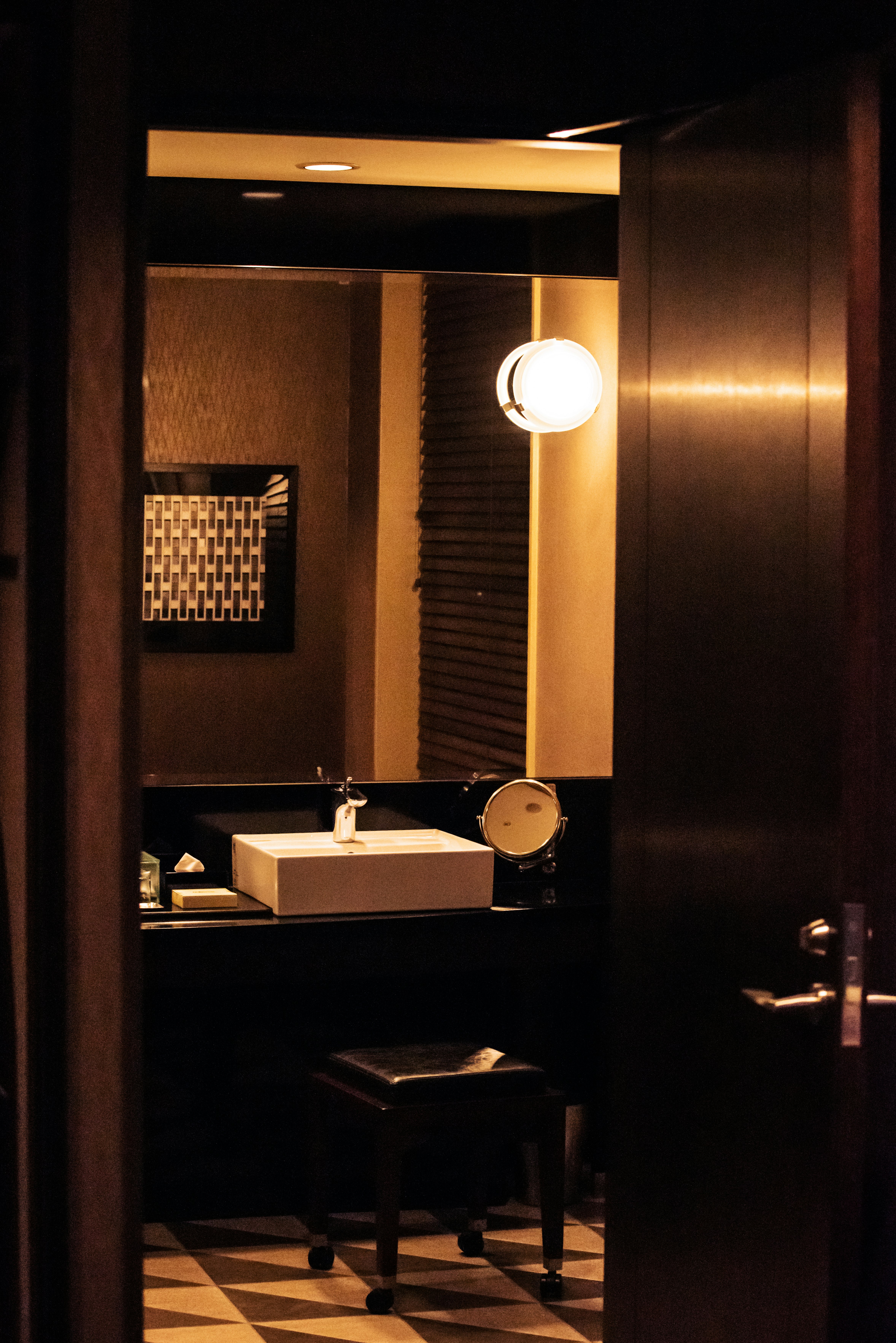 Image showing the interior of a dimly lit bathroom featuring a sink and a chair