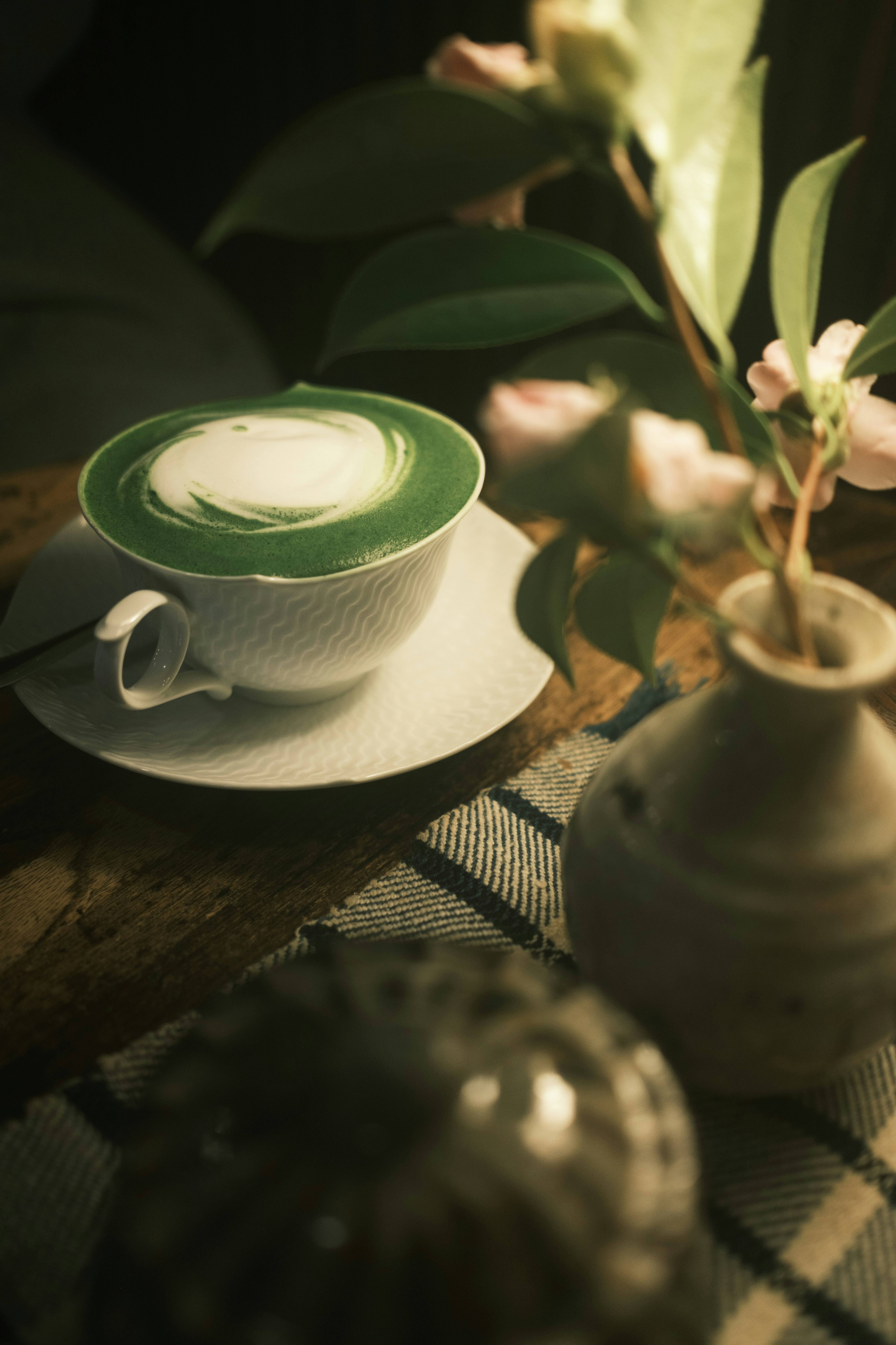 quiet cafe table with a cup and flowers