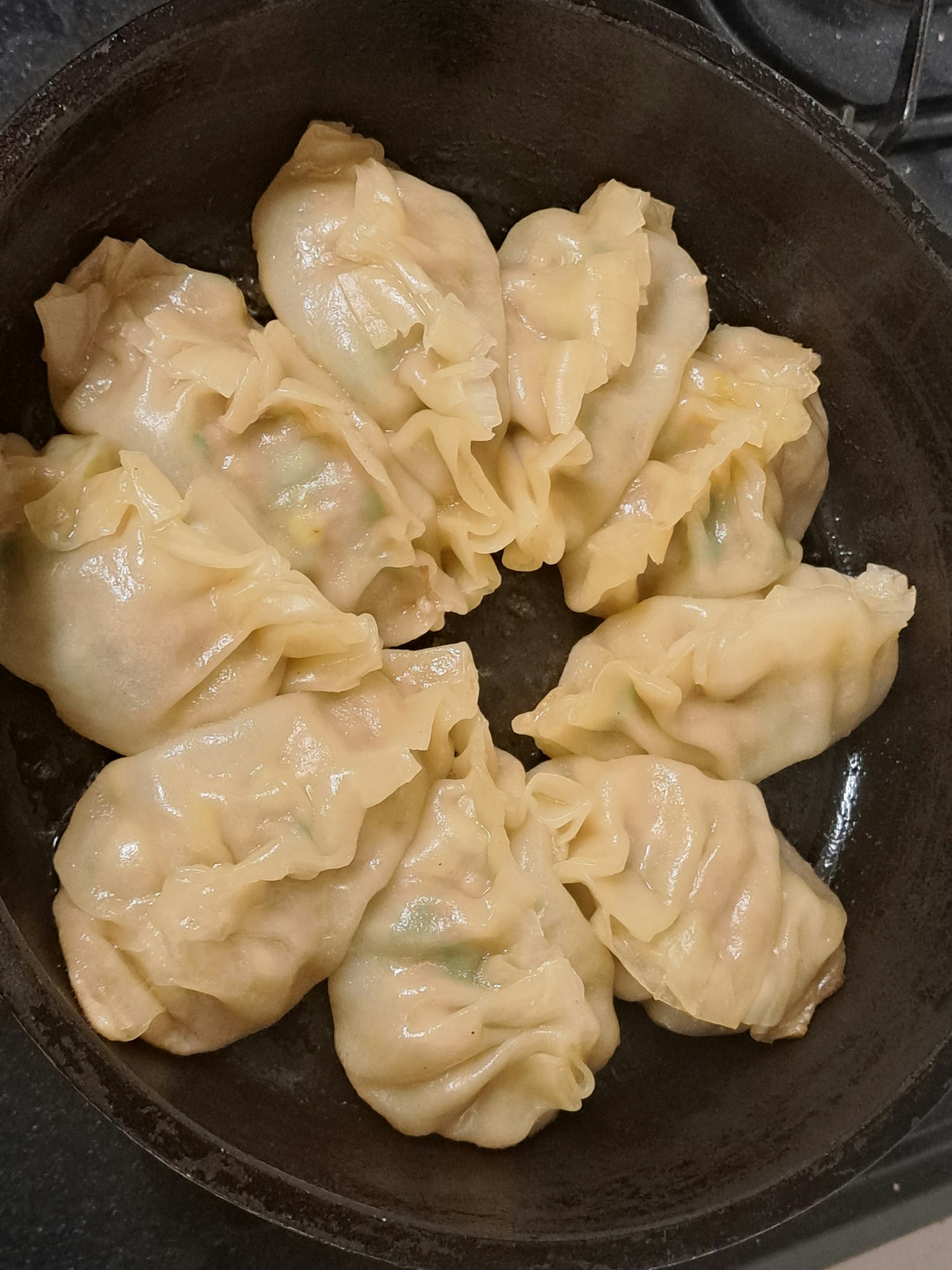 Grupo de dumplings dispuestos en una sartén