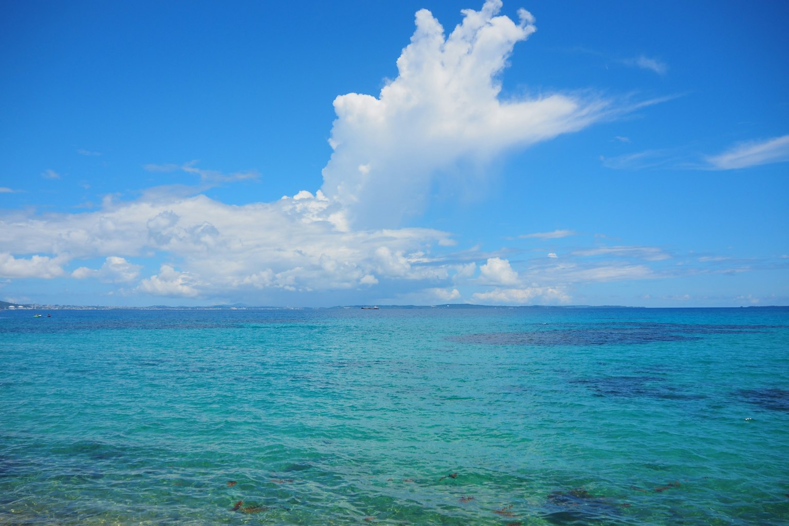 ทิวทัศน์สวยงามของทะเลสีน้ำเงินและท้องฟ้าพร้อมเมฆขาว
