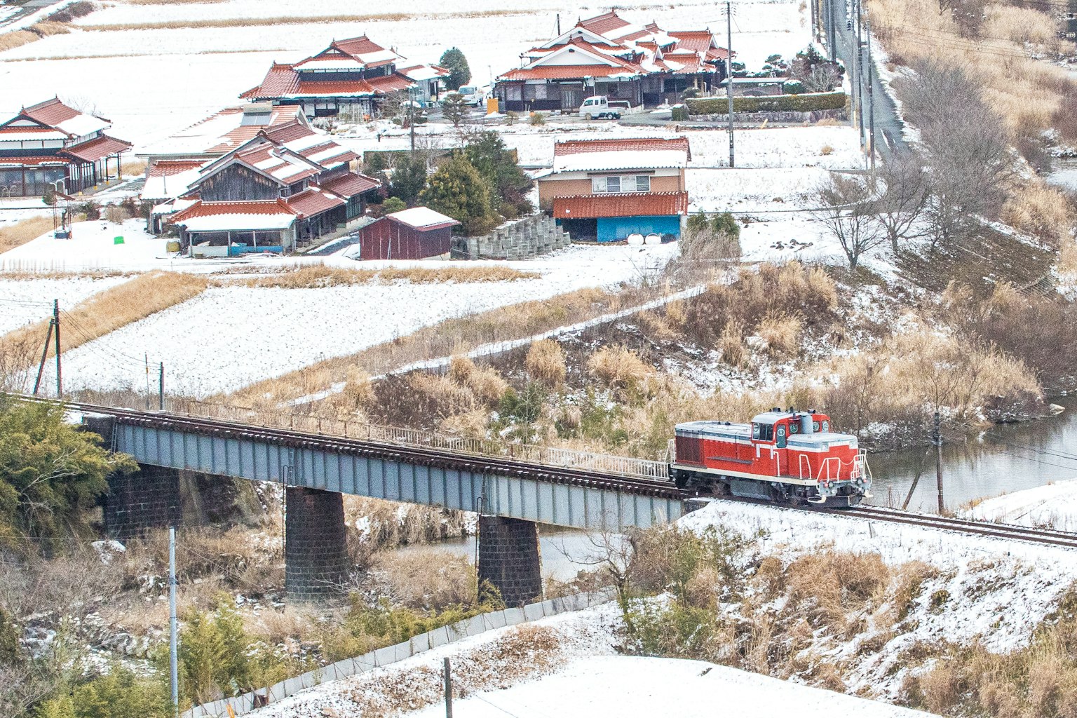 紅色火車穿越雪景中的橋