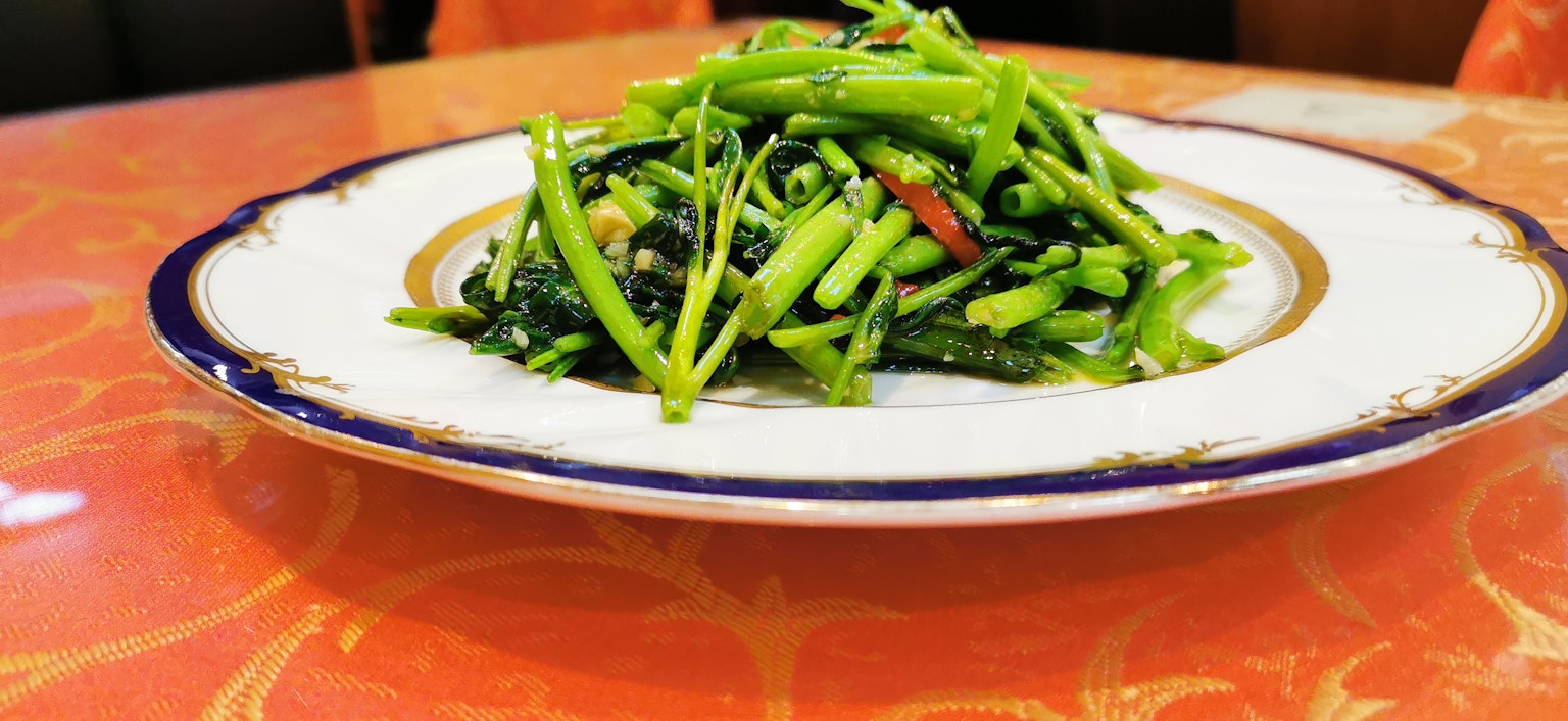 A plate of vibrant green vegetables beautifully arranged