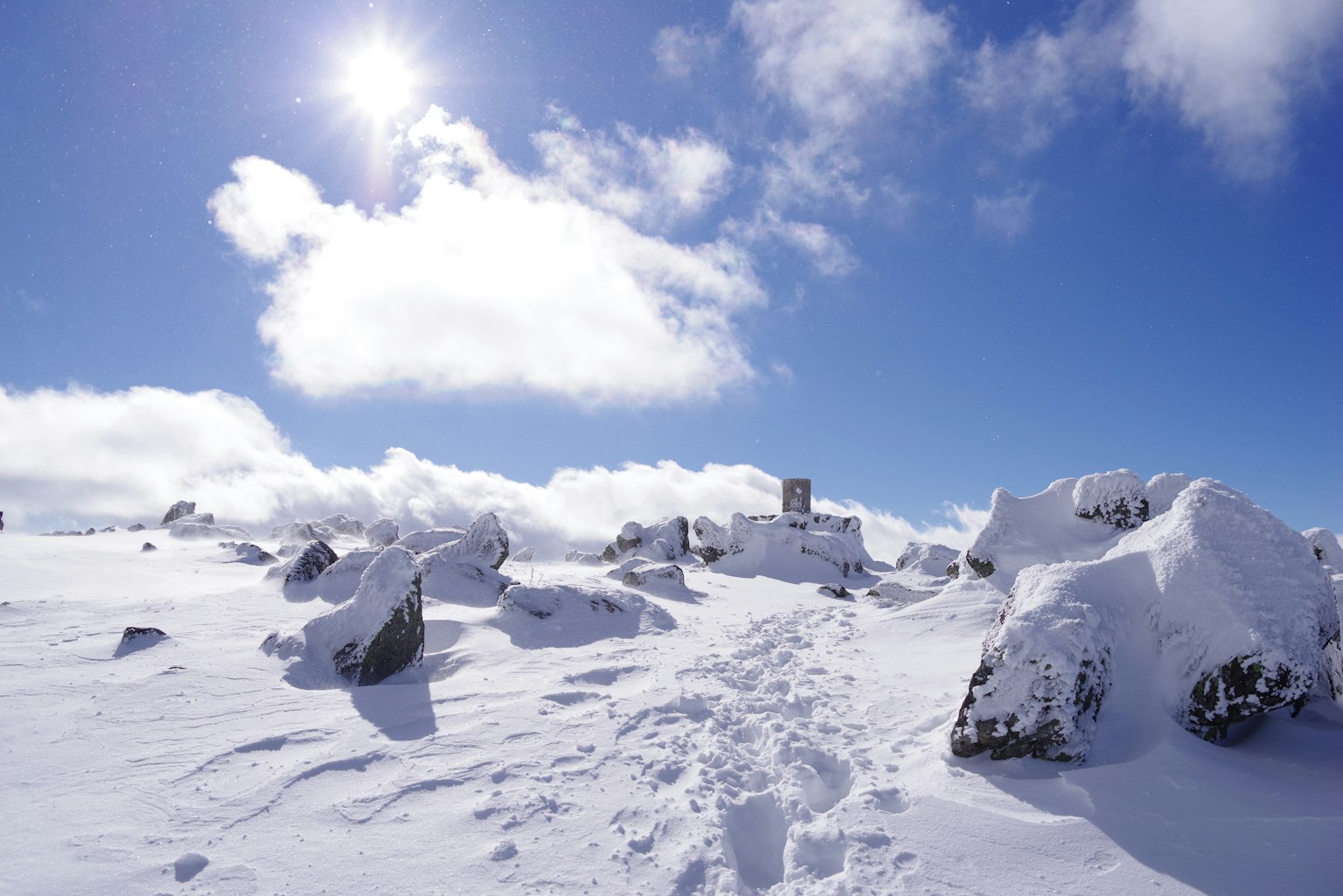 Snow-covered mountain landscape under a blue sky