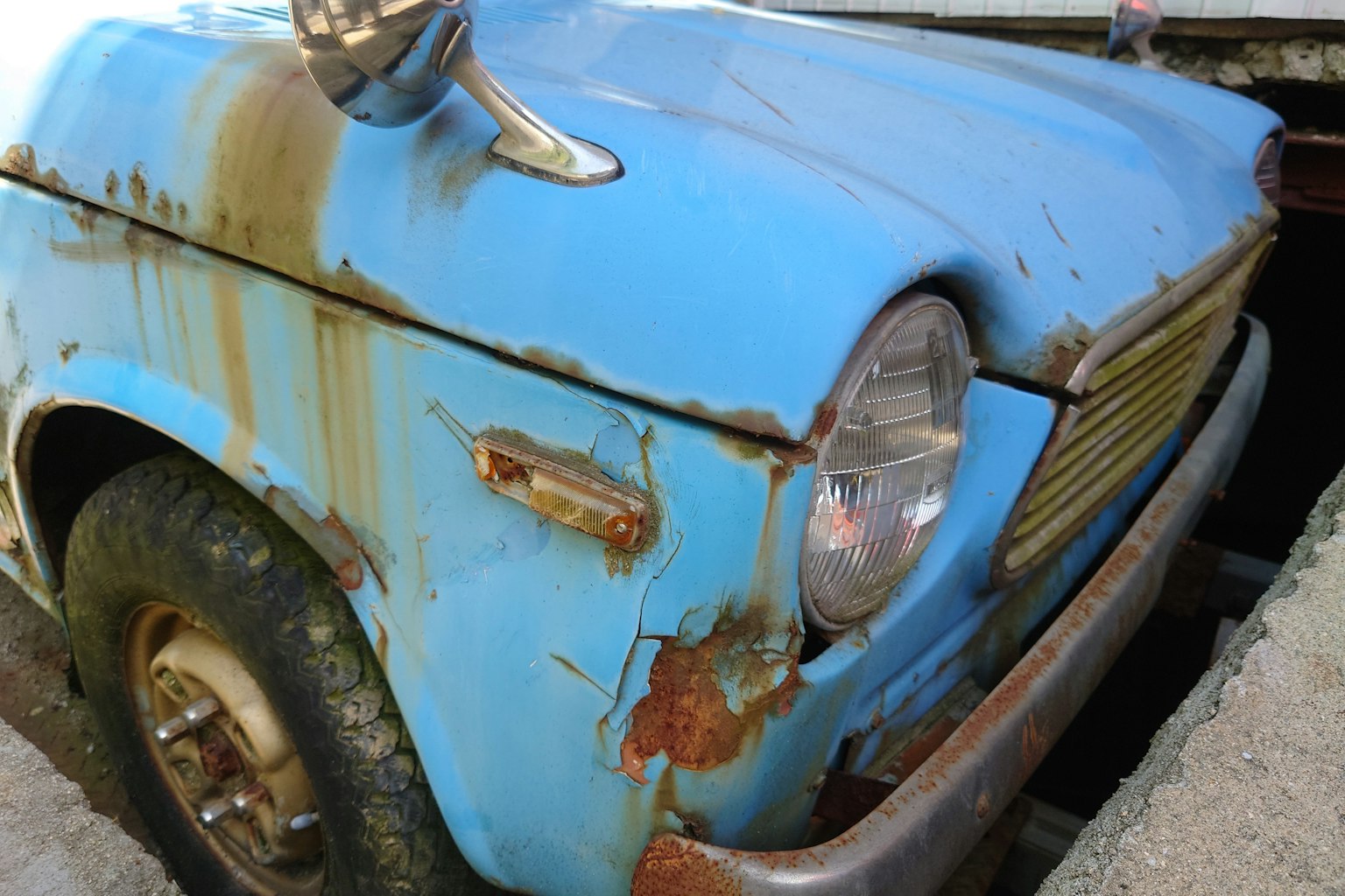旧蓝色汽车的特写,明显的生锈细节