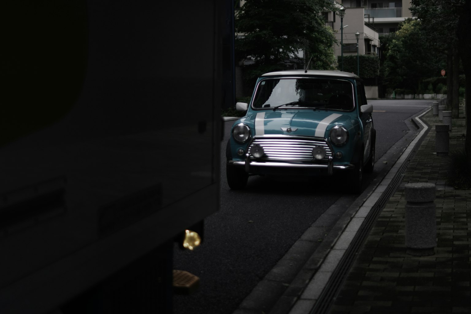 A blue Mini Cooper parked on a city street