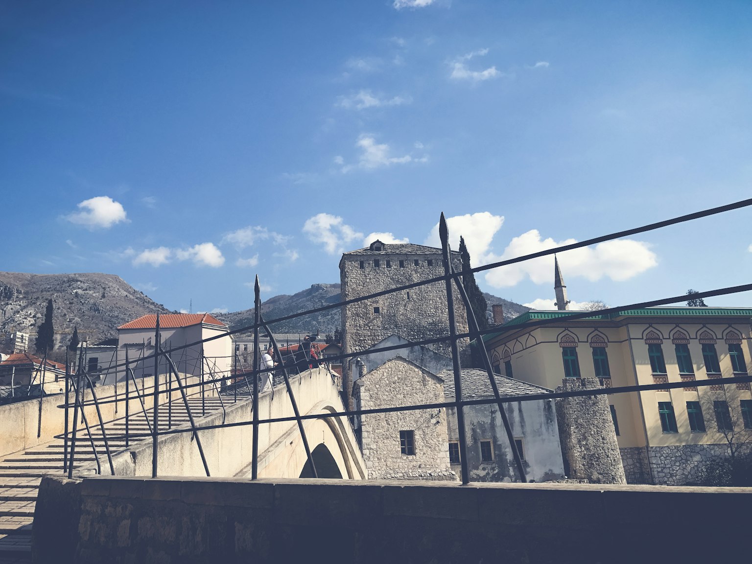Scenic view of old buildings and bridge under a beautiful blue sky
