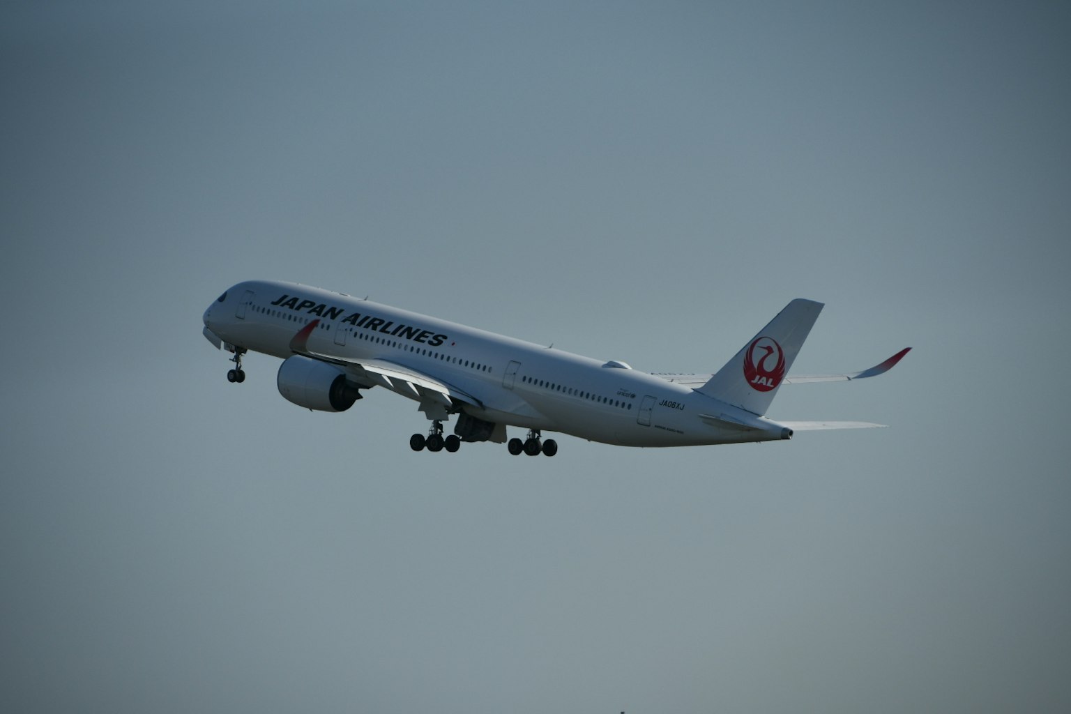 Airplane taking off against a blue sky