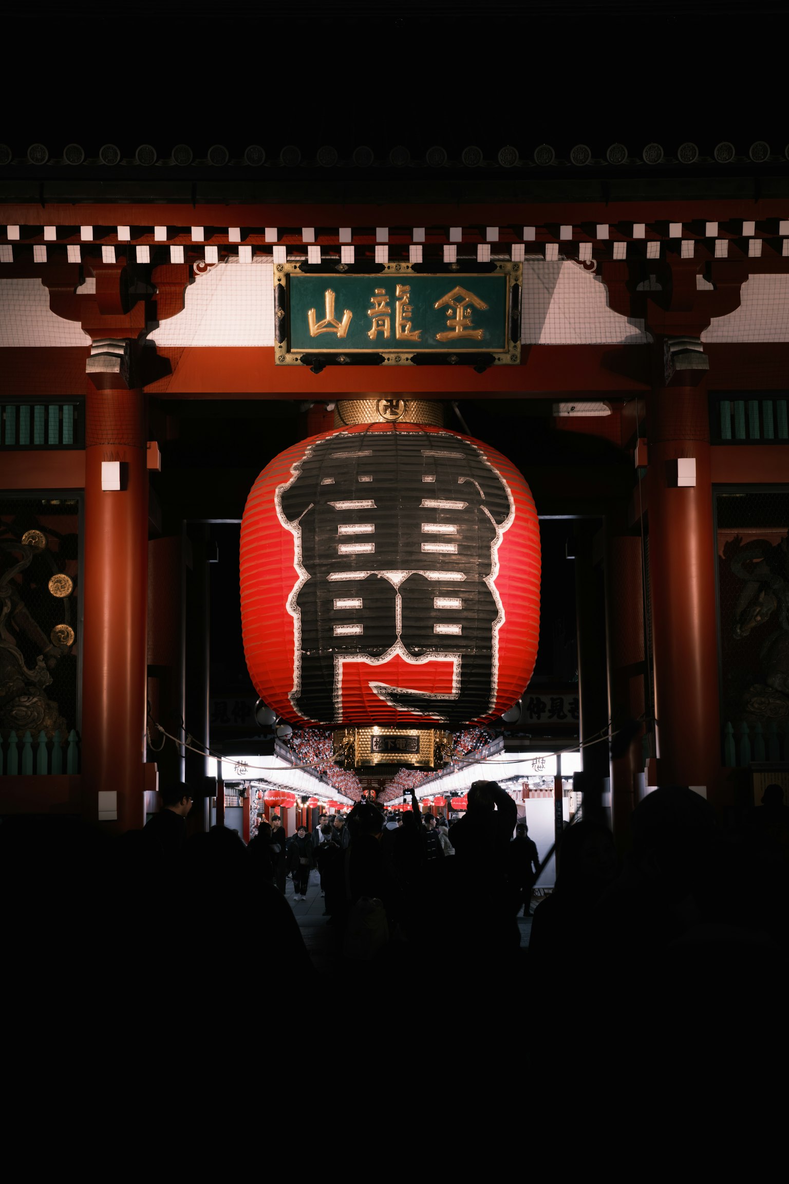Senso-ji Temple's Thunder Gate with a large red lantern illuminated at night