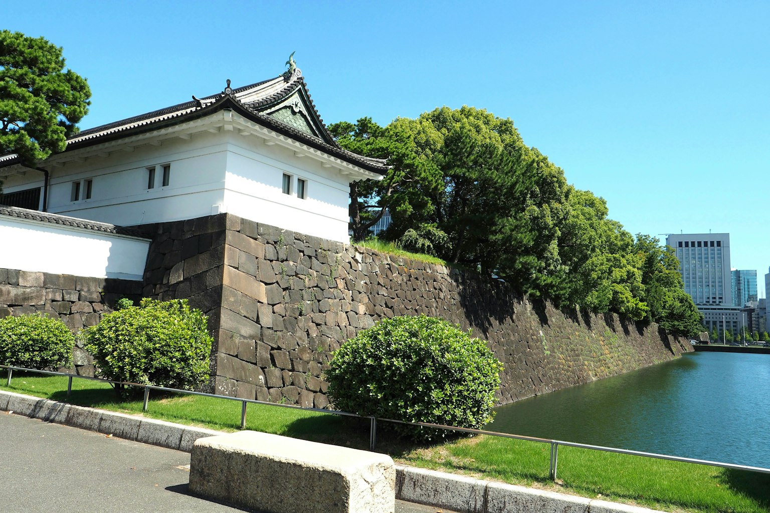 View of the white structure and stone wall of the Imperial Palace in Tokyo